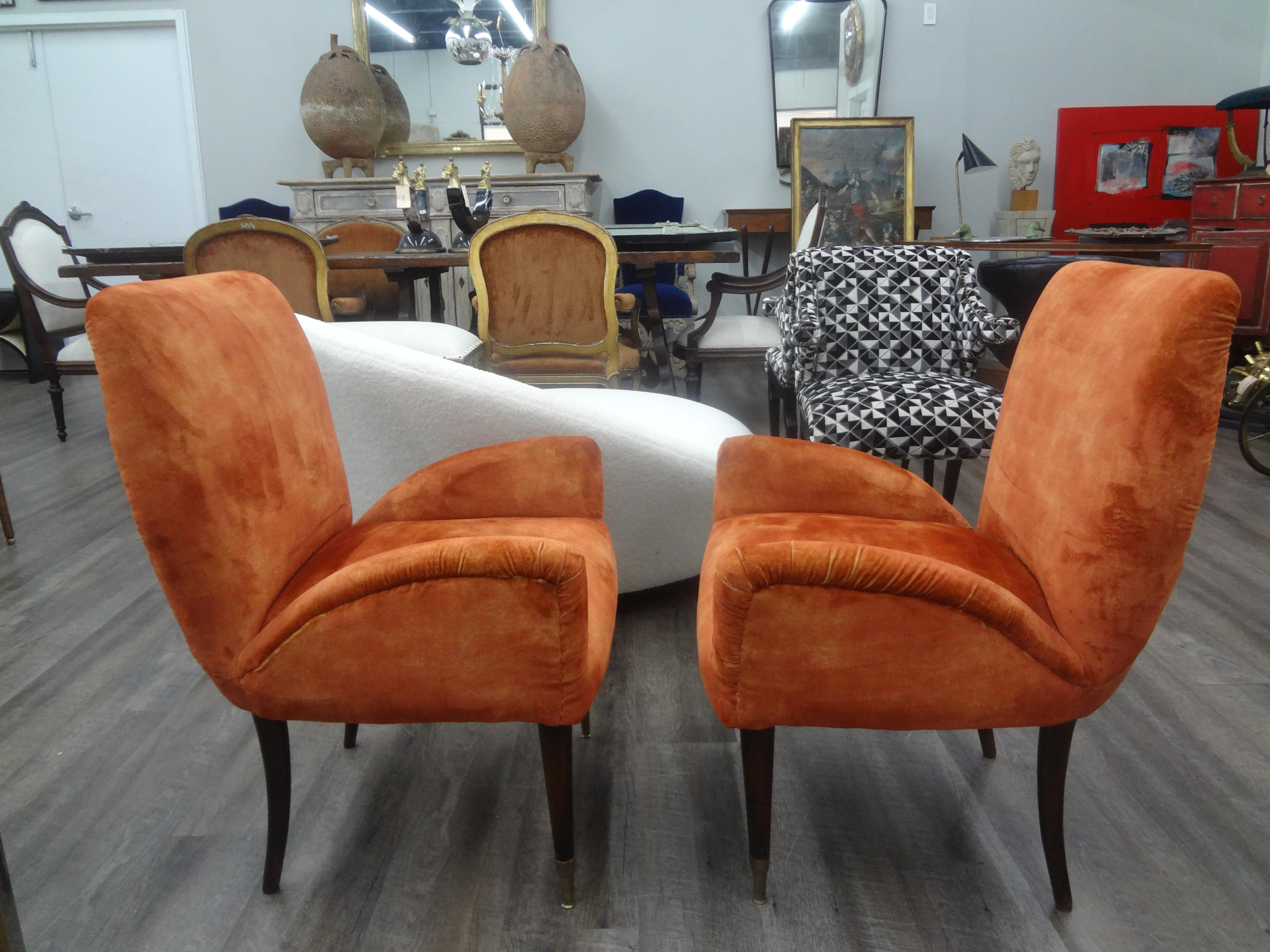 Pair of Italian modern sculptural lounge chairs.
This handsome pair of Italian midcentury lounge chairs were recently upholstered in dark orange Italian velvet and have beautiful tapered legs with bronze sabots.
Great sculptural design that's