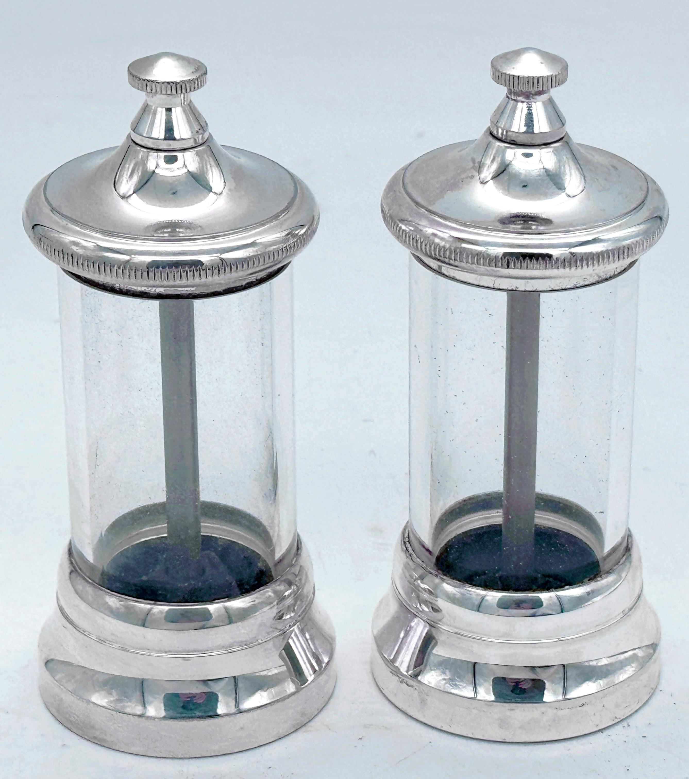 Pair of Italian Modern Silverplated & Glass Peppermills—Elegant Vintage Tableware

Elevate your dining experience with this stunning pair of modern silver-plated and glass Italian pepper mills. Combining sleek modern design with timeless Italian