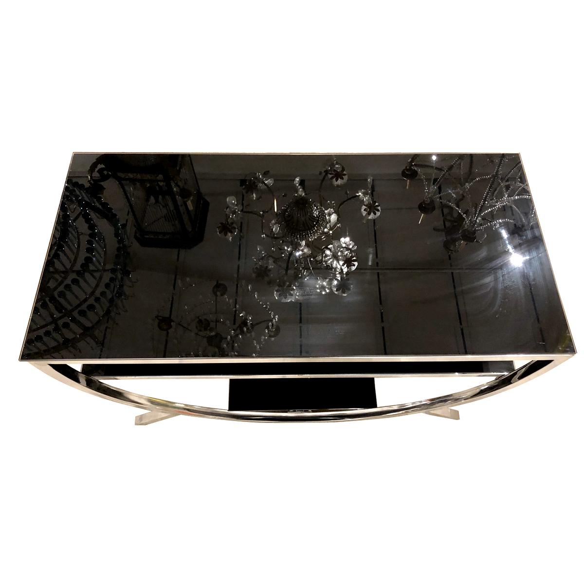 Pair of 1960's Italian nickel-plated consoles with black glass shelves. Sold as pair.

Measurements:
Height 24