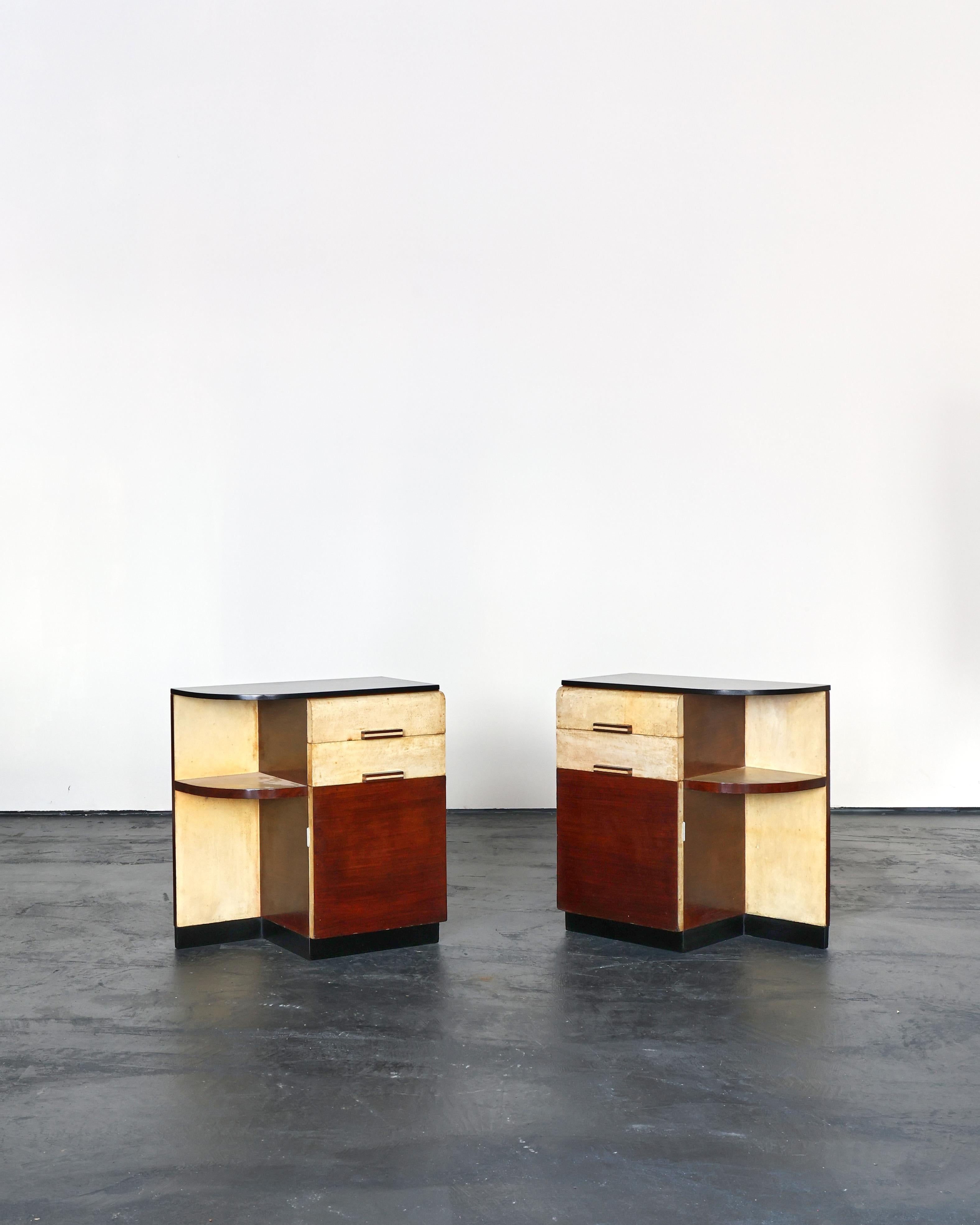 An exceptional pair of C.1940s northern Italian parchment/vellum bedside cabinets.

each features two drawers, one door, vellum covered shelf and a curved ebonised wood top.

Classic modernist design with vellum detailing throughout.

Nicely