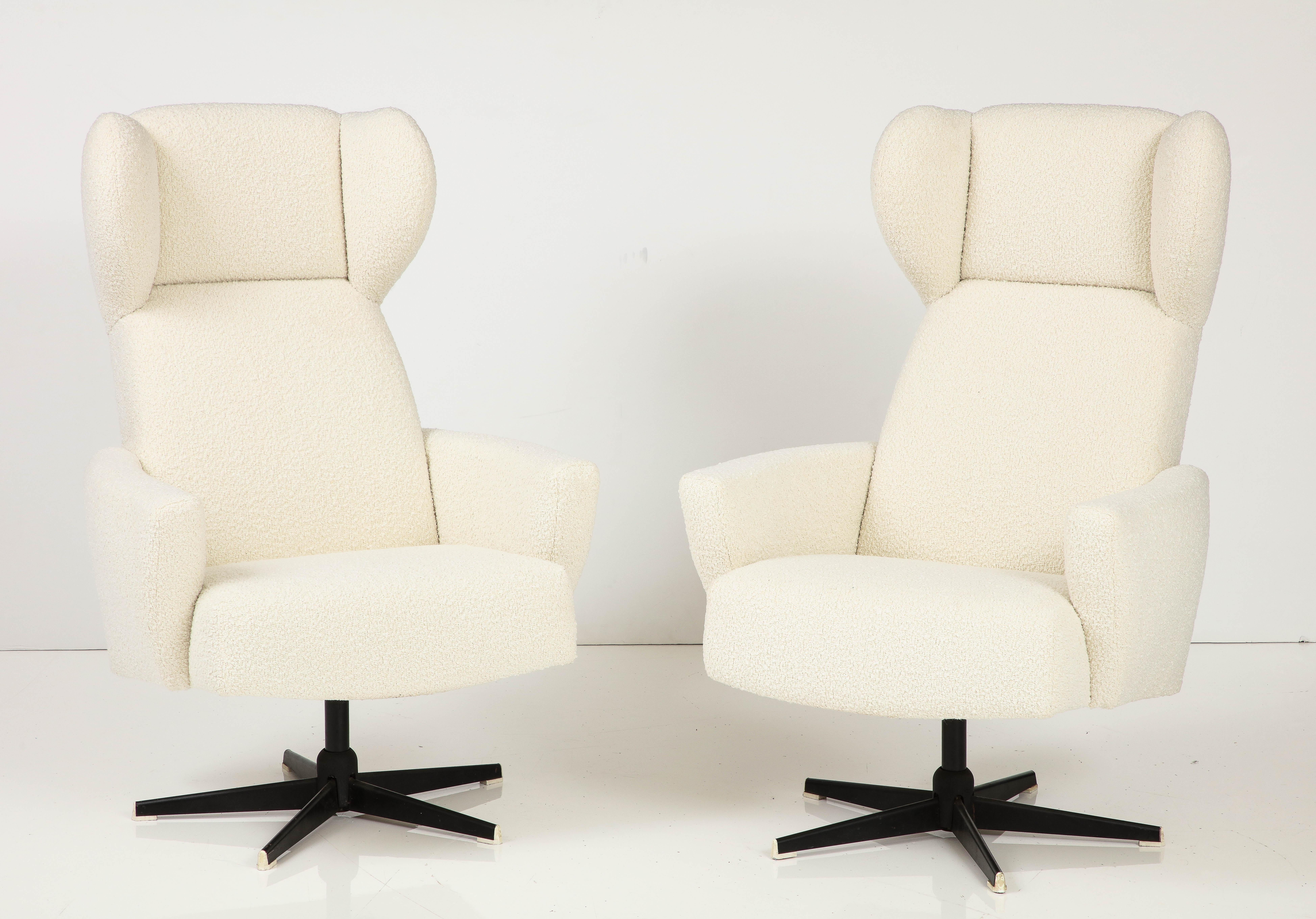A unique pair of Italian modernist high-back swivel chairs, circa 1960. Highly sculptural and futuristic, they would make for a great addition to a living room, office or media room. Very comfortable; newly reupholstered in our professional studio