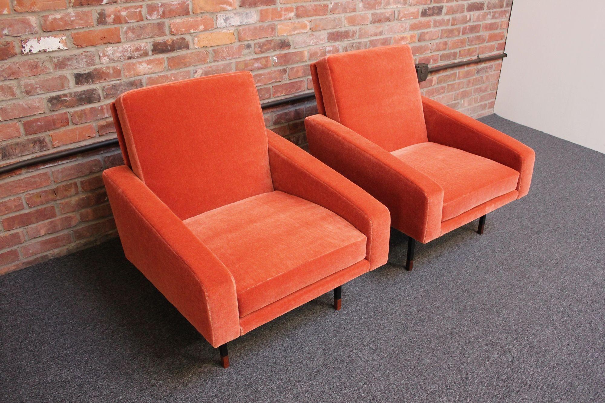 Pair of arm/lounge chairs designed by Franco Campo and Carlo Graffi and manufactured by Home Torino (ca. 1950s, Italy).
Composed of painted black metal frames with Italian walnut block feet and seats newly upholstered in a blood-orange/coral mohair