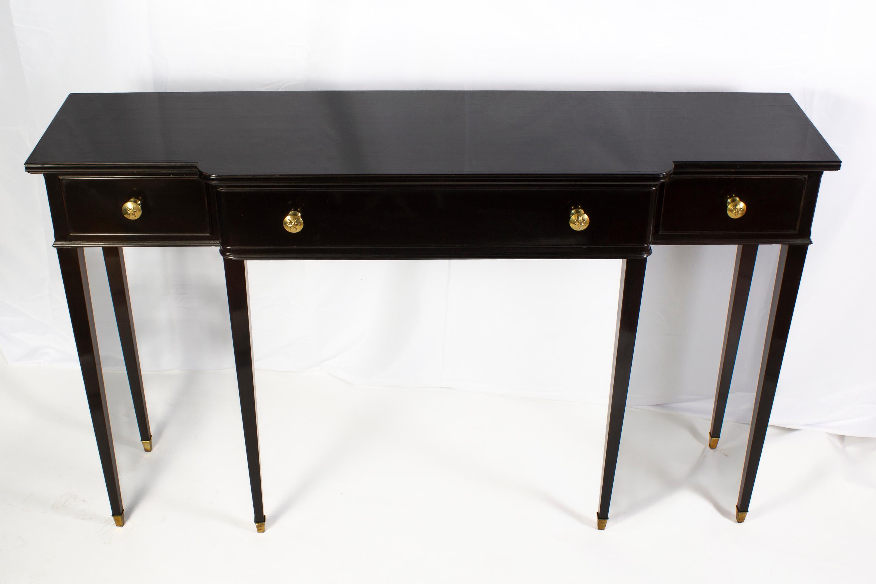 Elegant pair of Italian Midcentury Black lacquered console tables with three drawers ornate with brass .
 Square tapering legs with bronze mounts.
 Attributed to Paolo Buffa, famous Italian designer of the 50'.
 Excellent vintage condition.