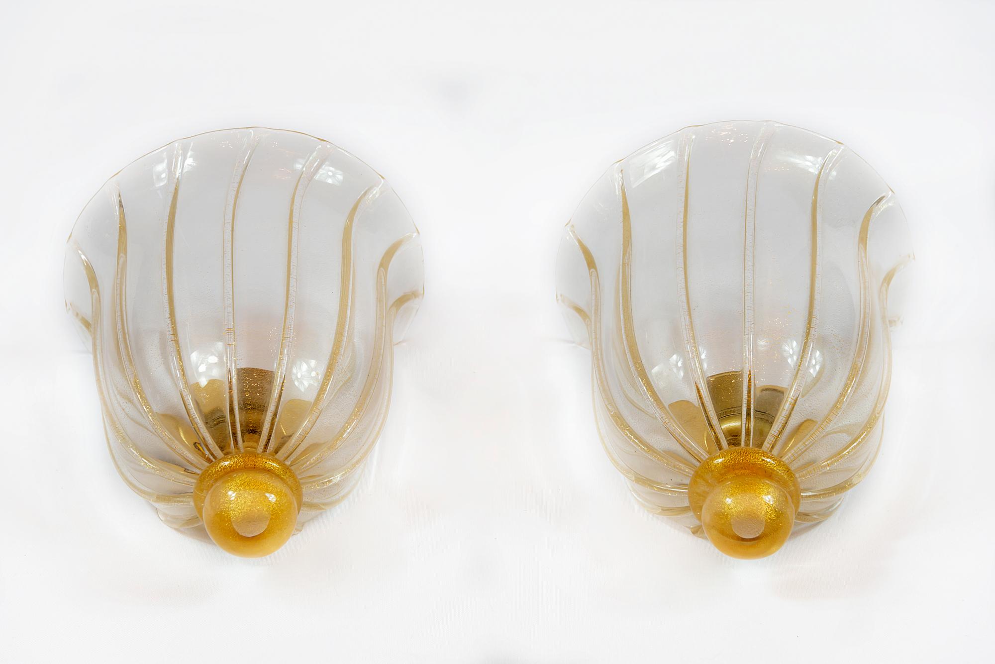 Pair of midcentury Italian wall light sconces handmade of Murano glass with inlaid gold dust and brass base by Seguso, circa 1970. Bulb is E27.