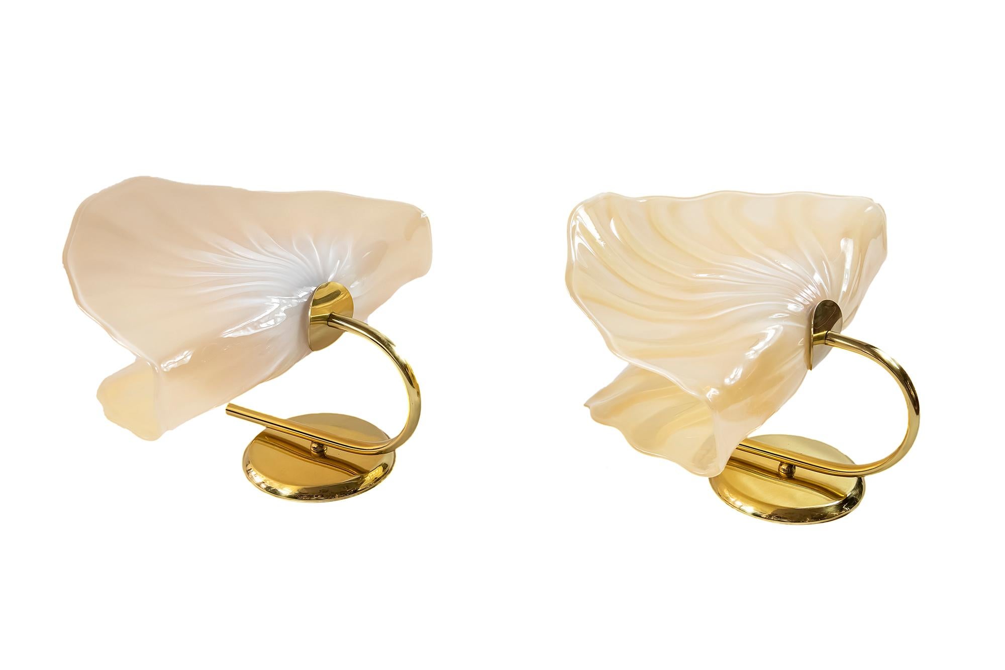 Pair of Italian wall light sconces are made of brass base and handmade Murano glass. Murano glass is light ivory. Bulbs are E27 ( 1 pcs. in each sconce).