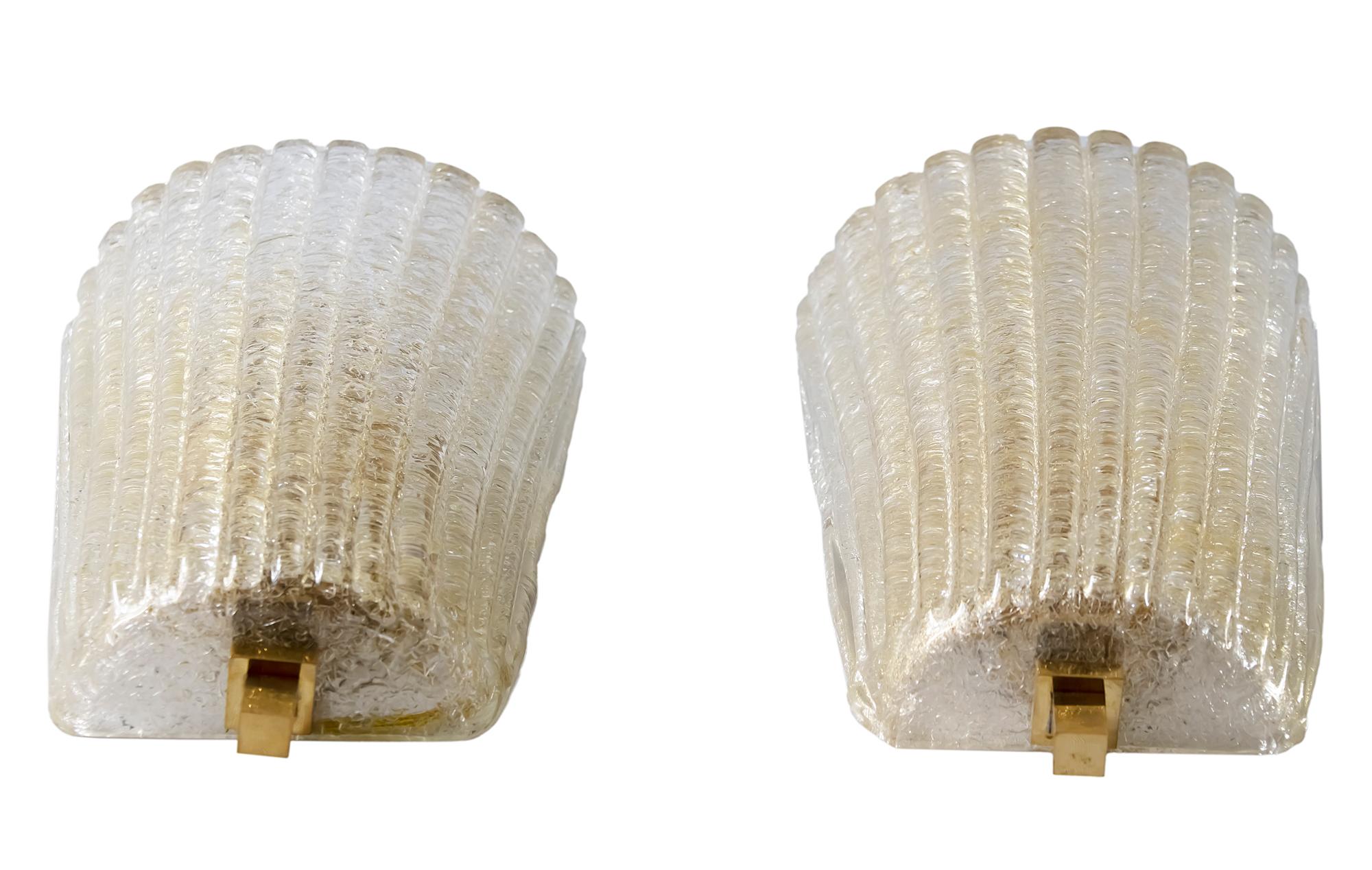 Pair of wall light sconces made of brass and handmade Murano glass.
Glass is transparent with inlaid gold with relief pattern.
Bulbs are E14 (2 pieces in each sconce).