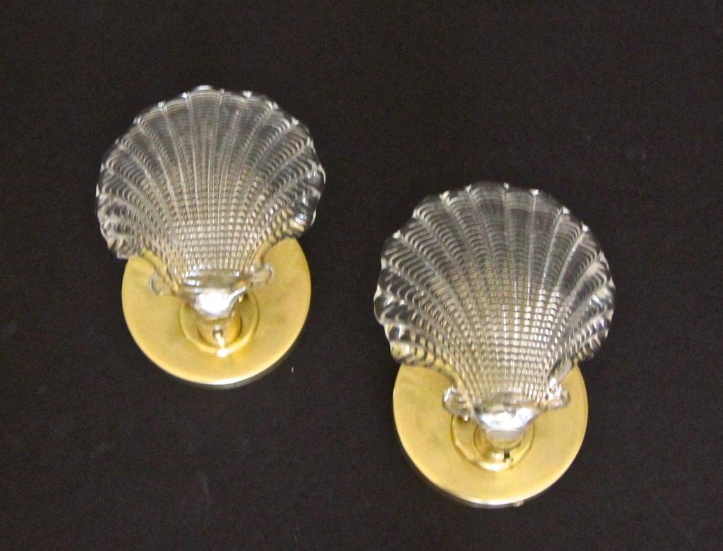 Pair of Italian clear textured glass clam shell shaped wall sconces with brass mountings, each takes one candelabra size bulb, newly wired.
    