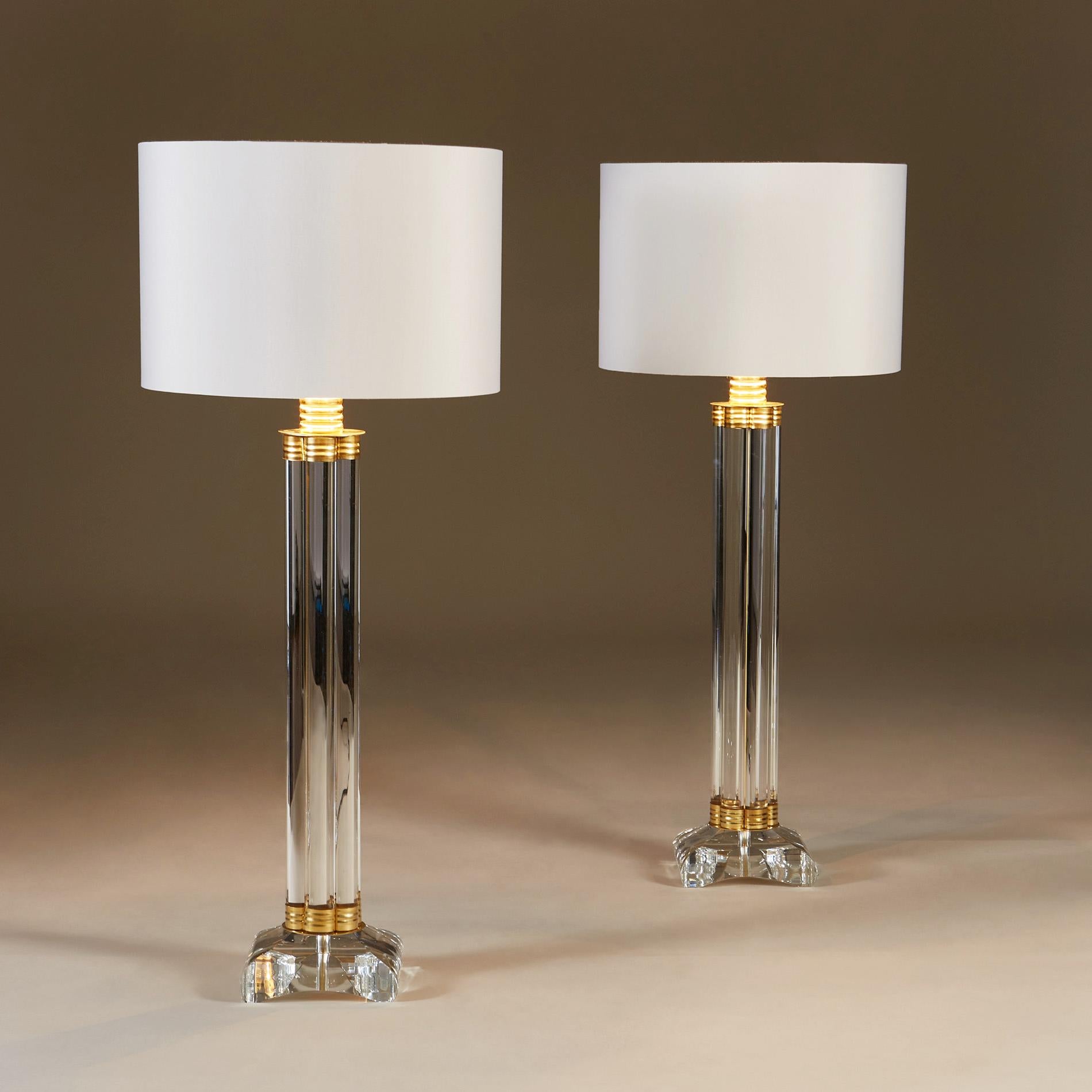 Striking pair of table lamps each made of six vertical glass rods held together at the top and bottom with decorative brass elements, standing on heavy square glass bases with rounded edges.
Height listed is without shades.
