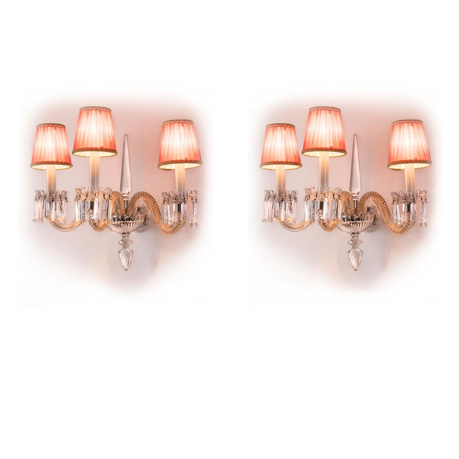 Pair of Italian crystal sconces, with three clear Murano glass scrolling arms realized in twisted rigadin placed in a chromed metal frame covered with a font shaped crystal cover. This charming sconces comes from a private residence in Genoa and