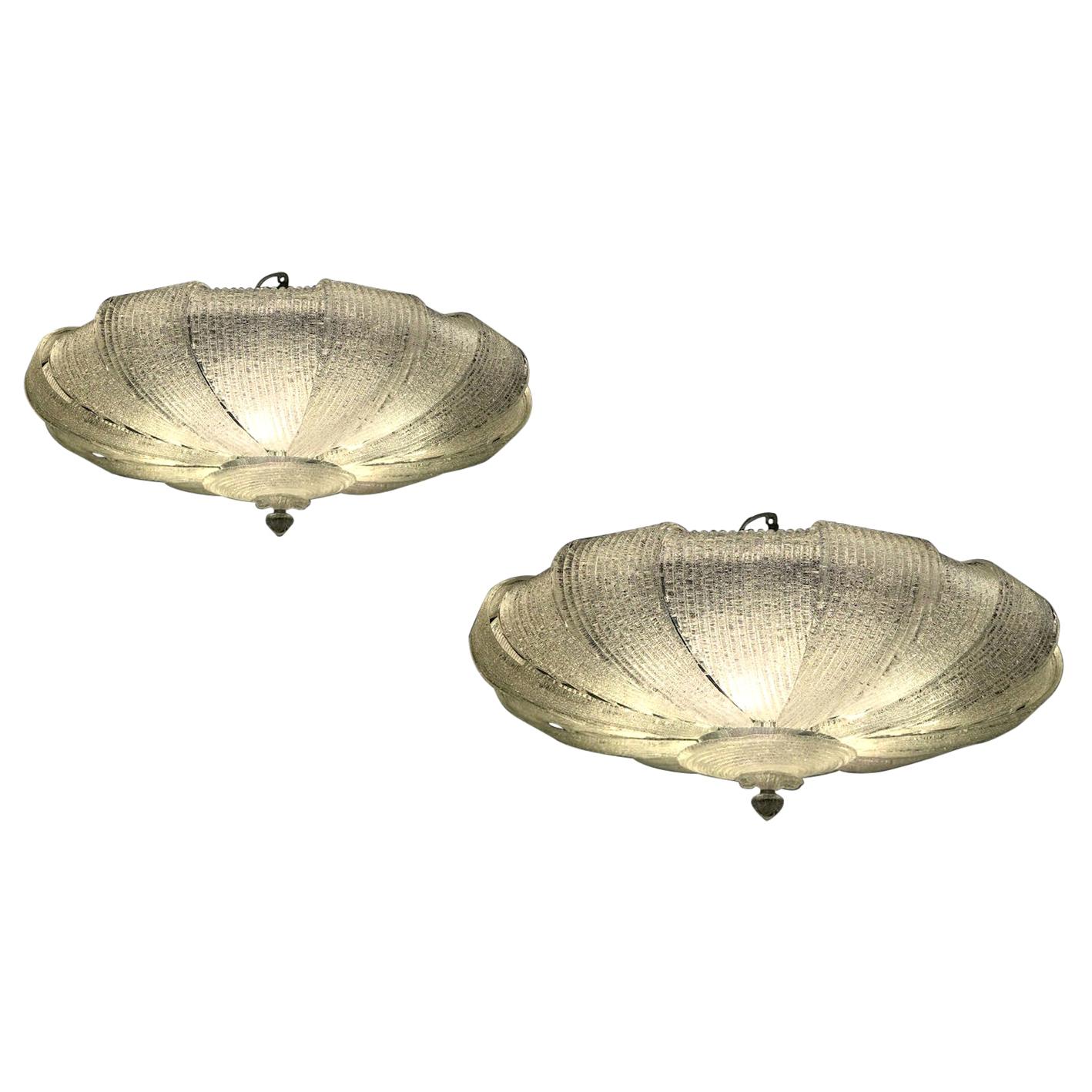 Pair of Italian Murano glass leaves modern ceiling lights. 
Exclusive production with precious Murano glass leaves.
 Available with clear and amber glass. 
Six E 27 light bulbs. We can wire for your country standards.
 