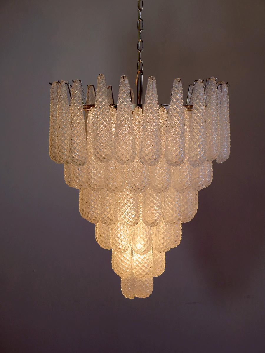 Pair of huge Italian vintage Murano chandeliers made by 75 glass petals (transparent crystal, smooth outside, with crystal powder and then rough inside in a chrome frame.
Period: 1970s-1980s.

Dimensions: 65 inches (165 cm) height with chain; 37.40