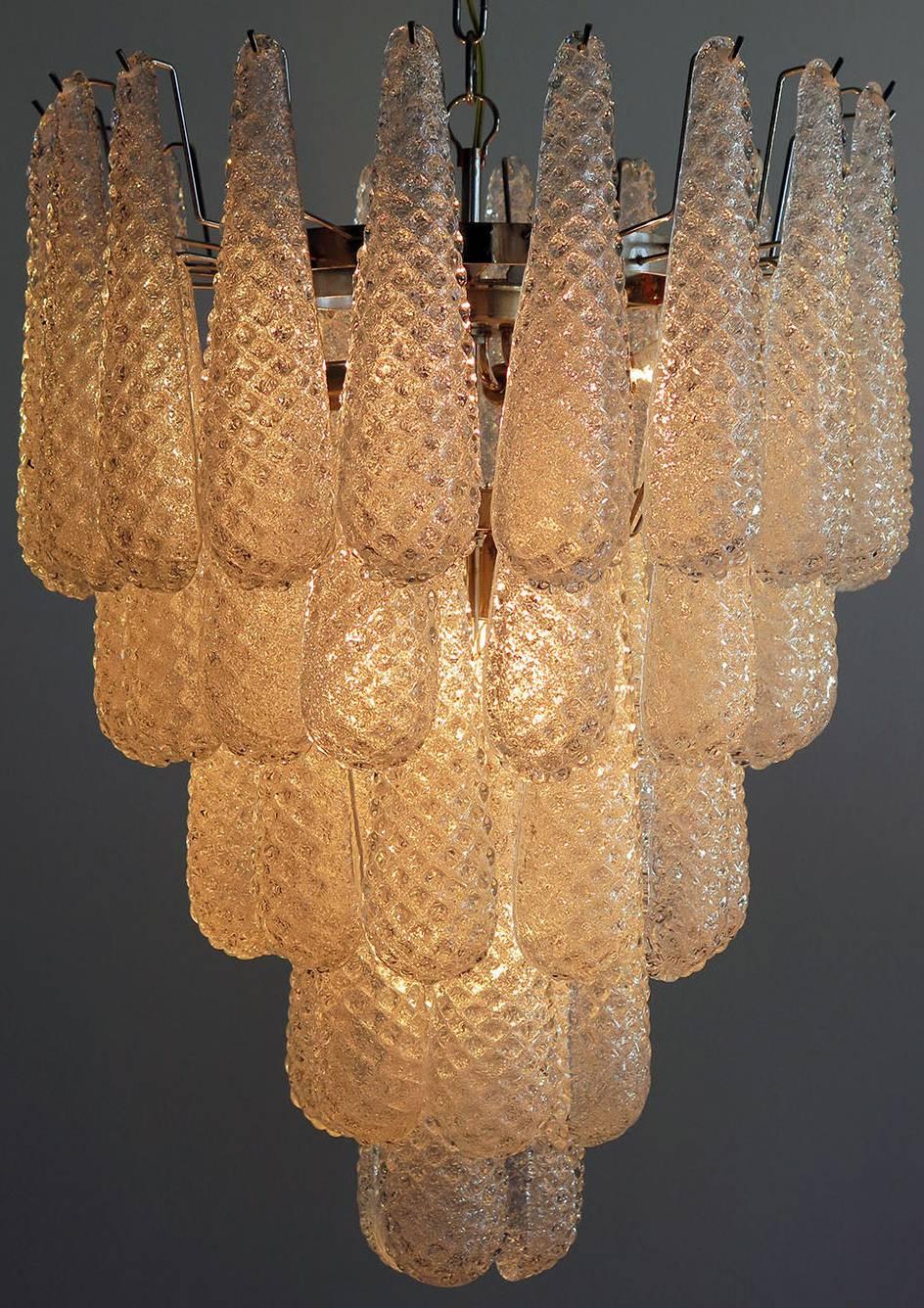 Pair of huge Italian vintage Murano chandeliers made by 52 glass petals (transparent crystal, smooth outside, with crystal powder and then rough inside in a chrome frame.
Period: 1970s-1980s

Dimensions: 55.10 inches (140 cm) height with chain;