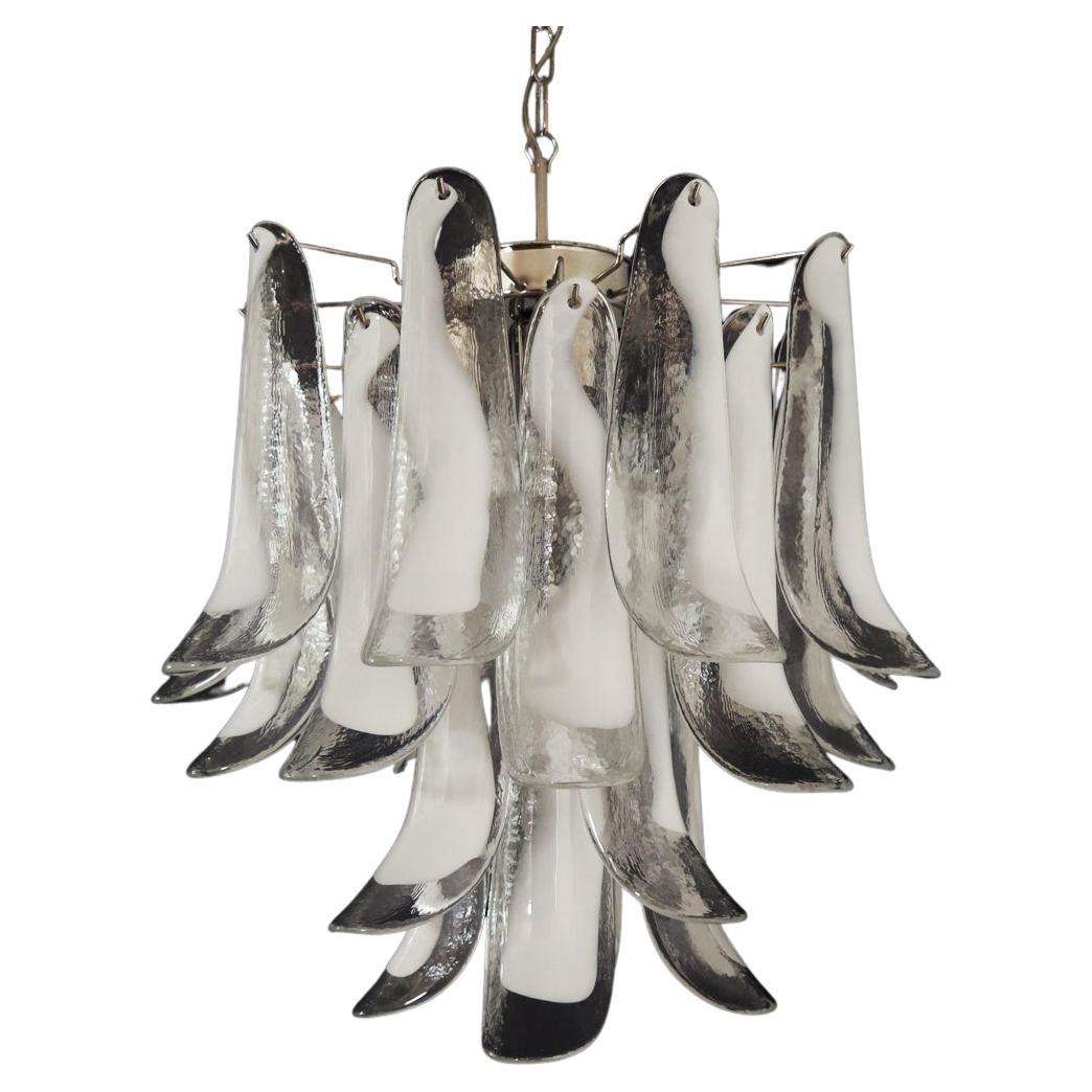 Italian vintage Murano chandelier made by 26 glass petals (trasparent and white “lattimo”) in a chrome frame.
Period: 1980's
Dimensions: 47,250 inches (120 cm) height with chain; 23,62 inches (60 cm) height without chain; 19,70 inches (50 cm)