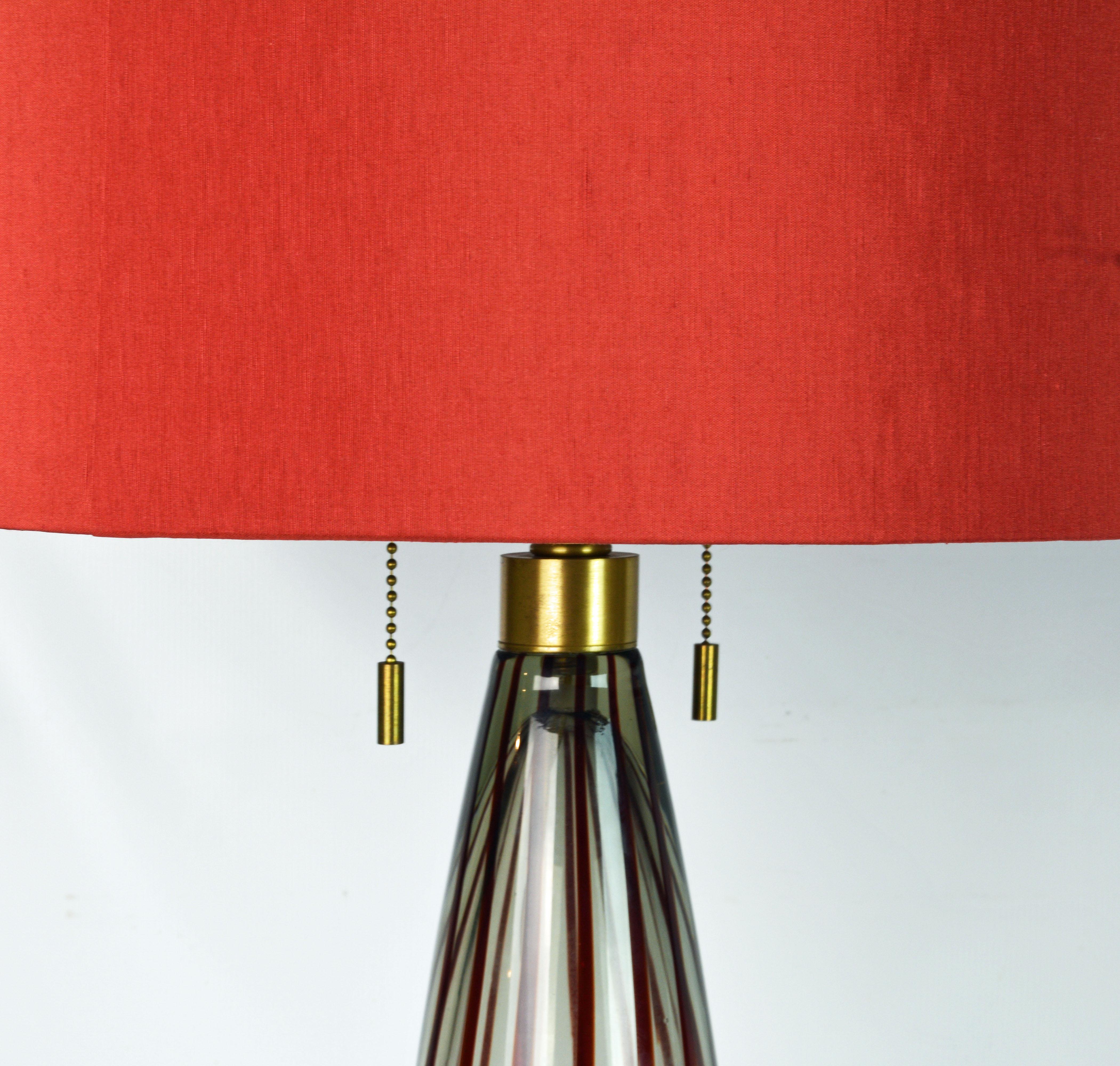 These Donghia lamps made in Murano Italy are very elegant with original red shades and red glass finial. Donghia are known for impeccable design and quality as demonstrated in these very tasteful lamps. They are etched Donghia near the bottom of