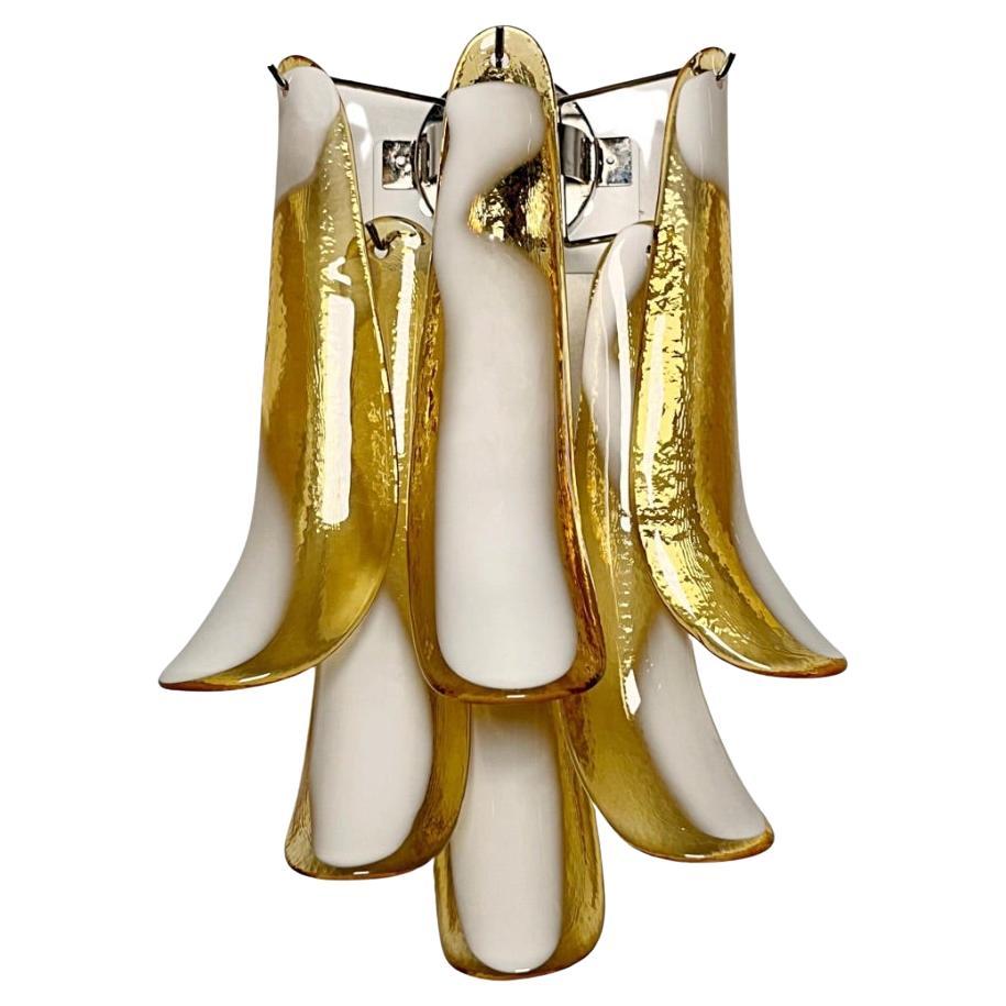 Pair of Vintage Italian Murano appliques. Wall lights have 6 caramel and lattimo glass petals (for each applique) in a chrome frame.
Period: late XX century
Dimensions: 18,60 inches (48 cm) height; 12 inches (31 cm) width; 7,75 inches (20 cm) depth