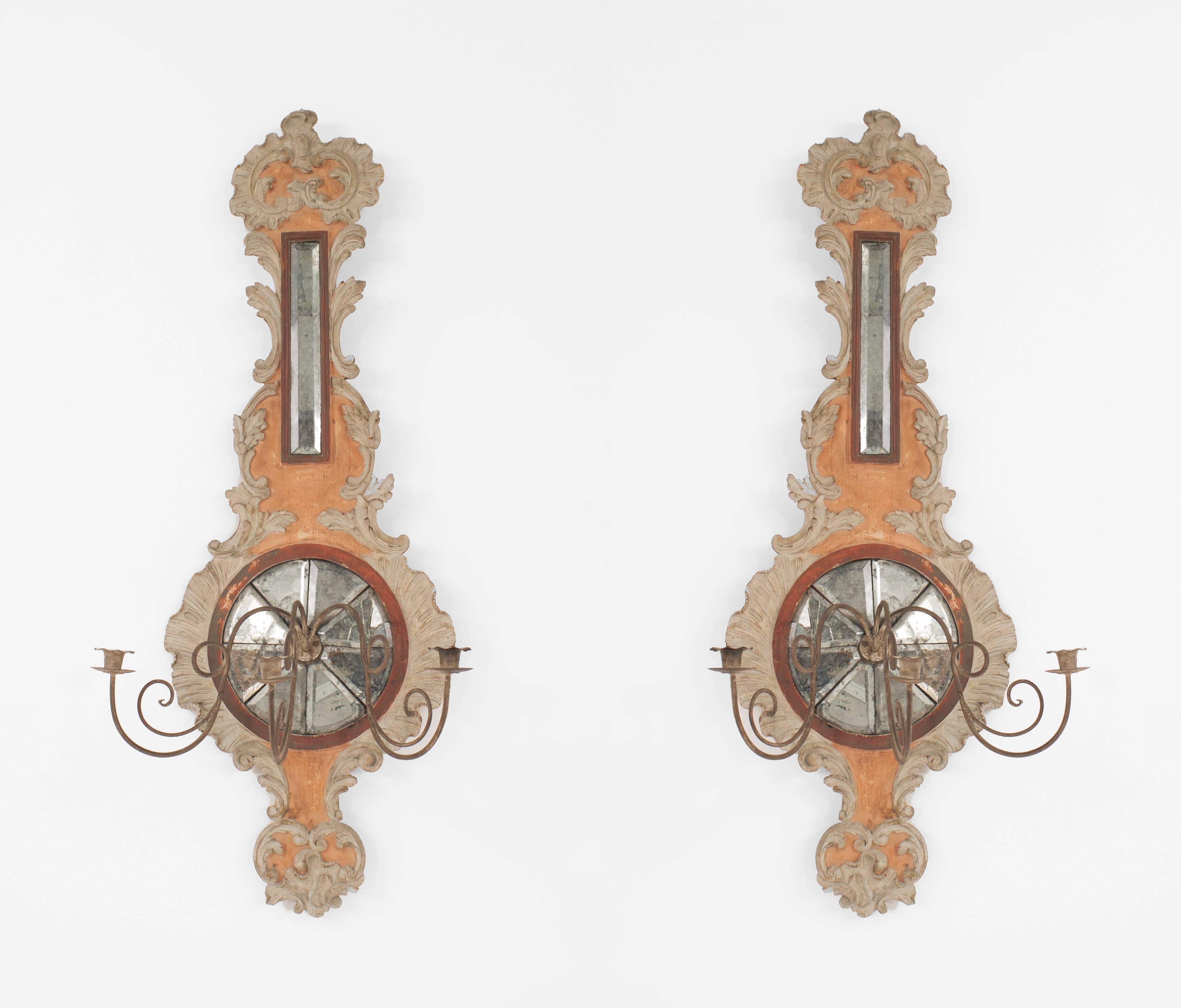 Pair of Italian Neo-classic (19th-20th century) beige and peach painted & carved wood barometer-shaped wall sconces with 3 patinated brass arms and mirrored detail (one piece of glass 