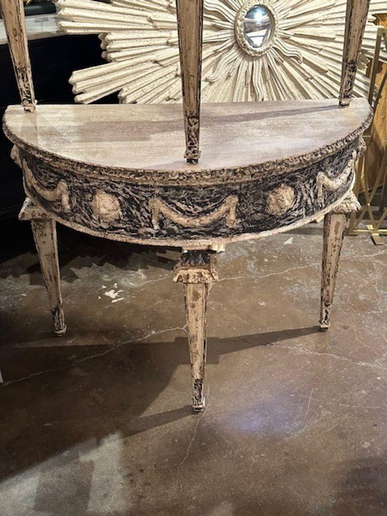 Pair of Italian carved and painted Neo-classical style demi-lune consoles. A timeless and classic touch for a fine interior!
