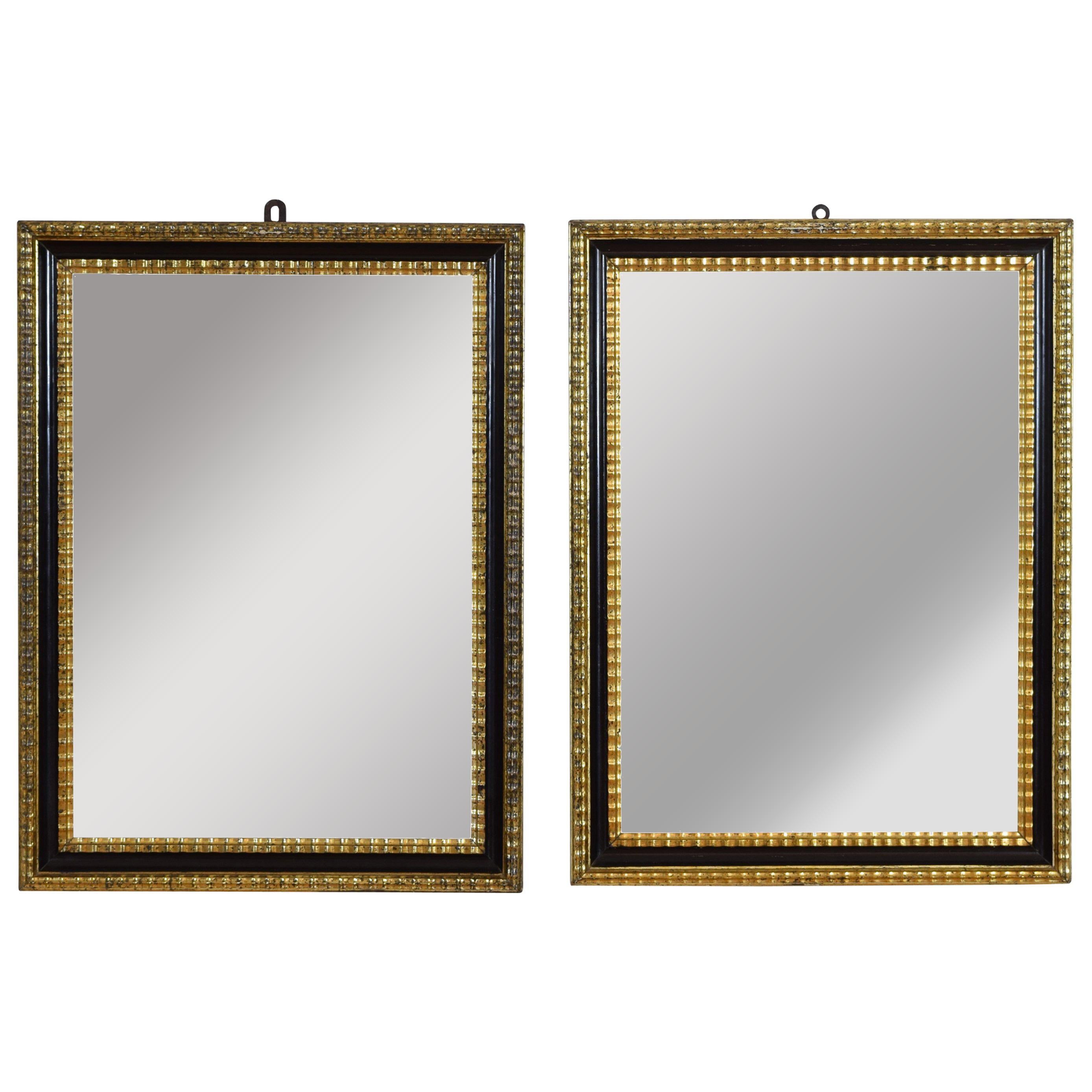 Pair of Italian Neoclassic Ebonized and Giltwood Mirrors
