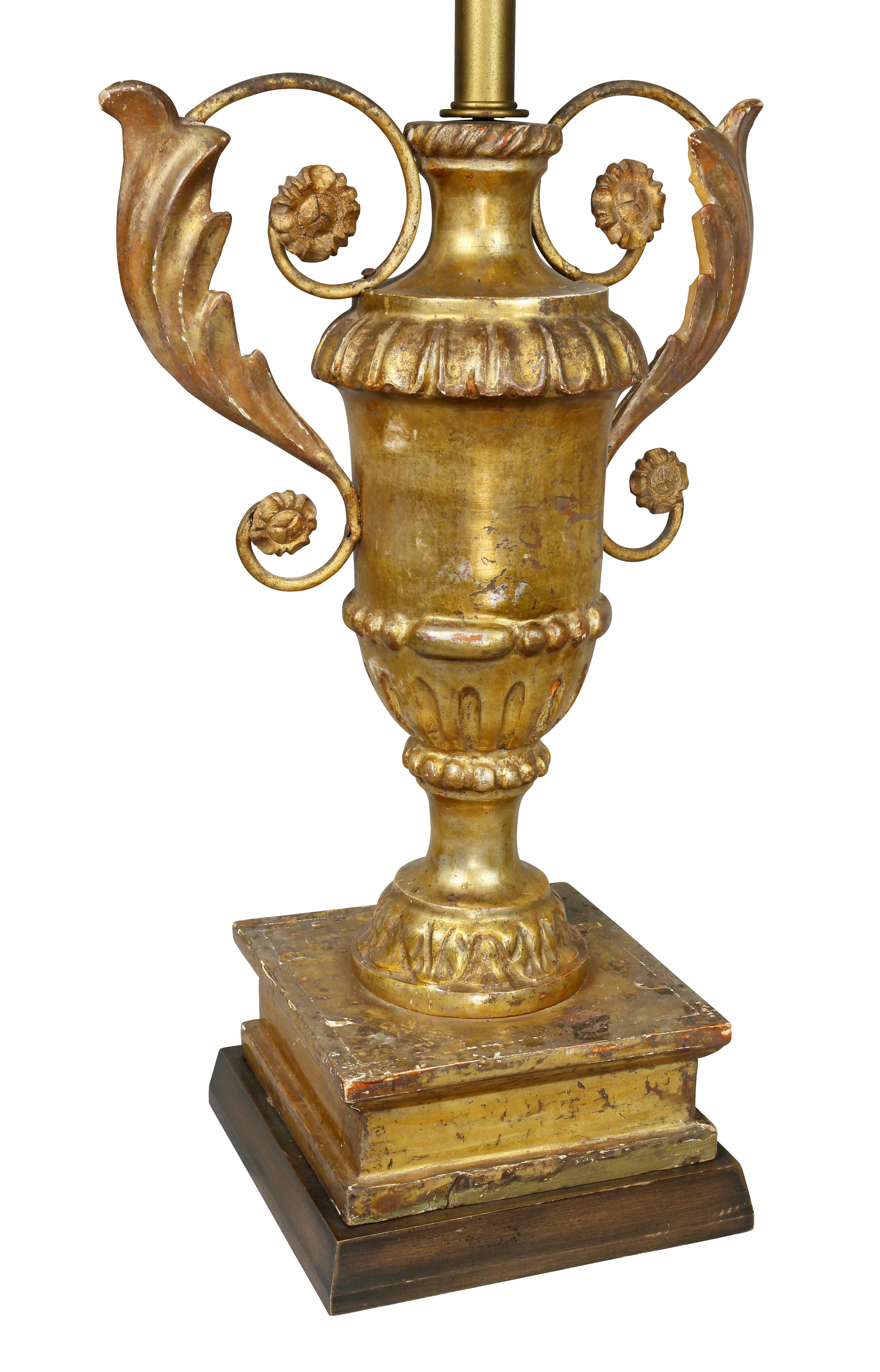 Each of urn form with scroll handles with acanthus carving, square plinth base.