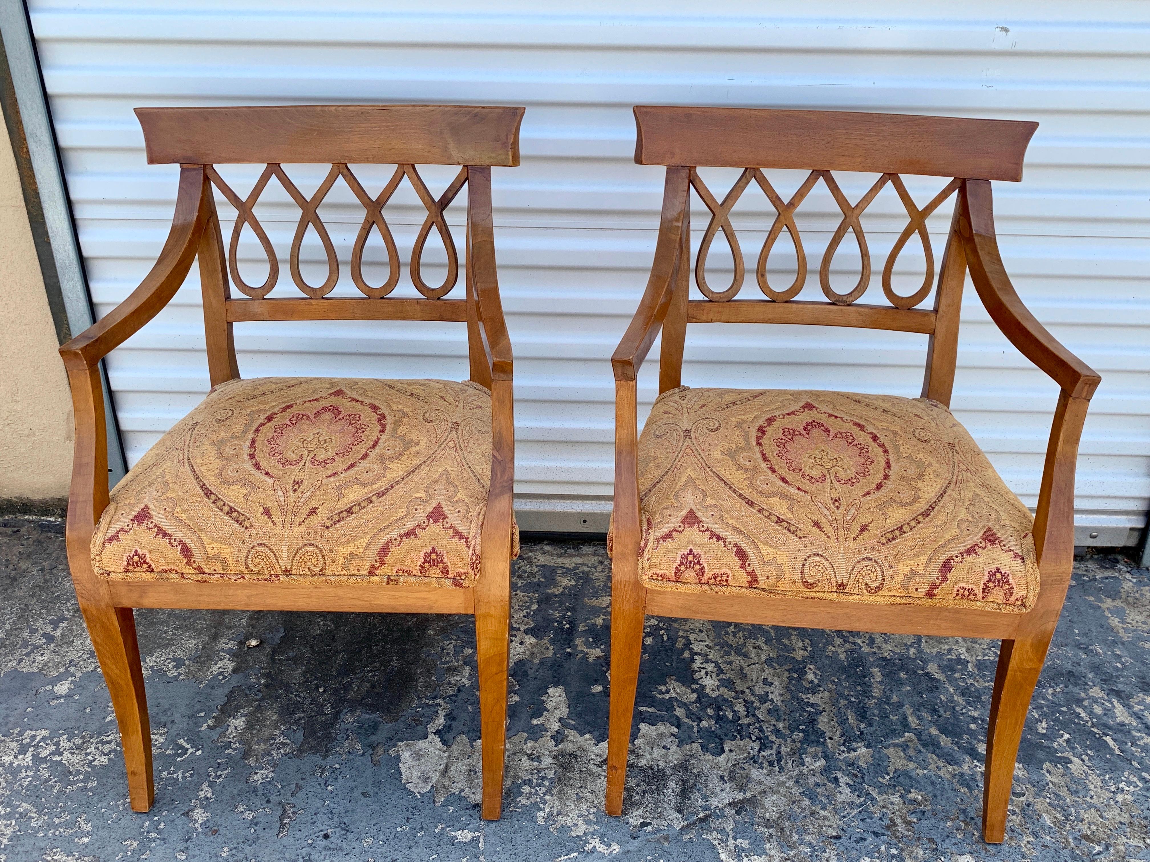 Pair of Italian neoclassic olive wood armchairs, each one with undulating backrests, and upholstered seat. Measures: 25