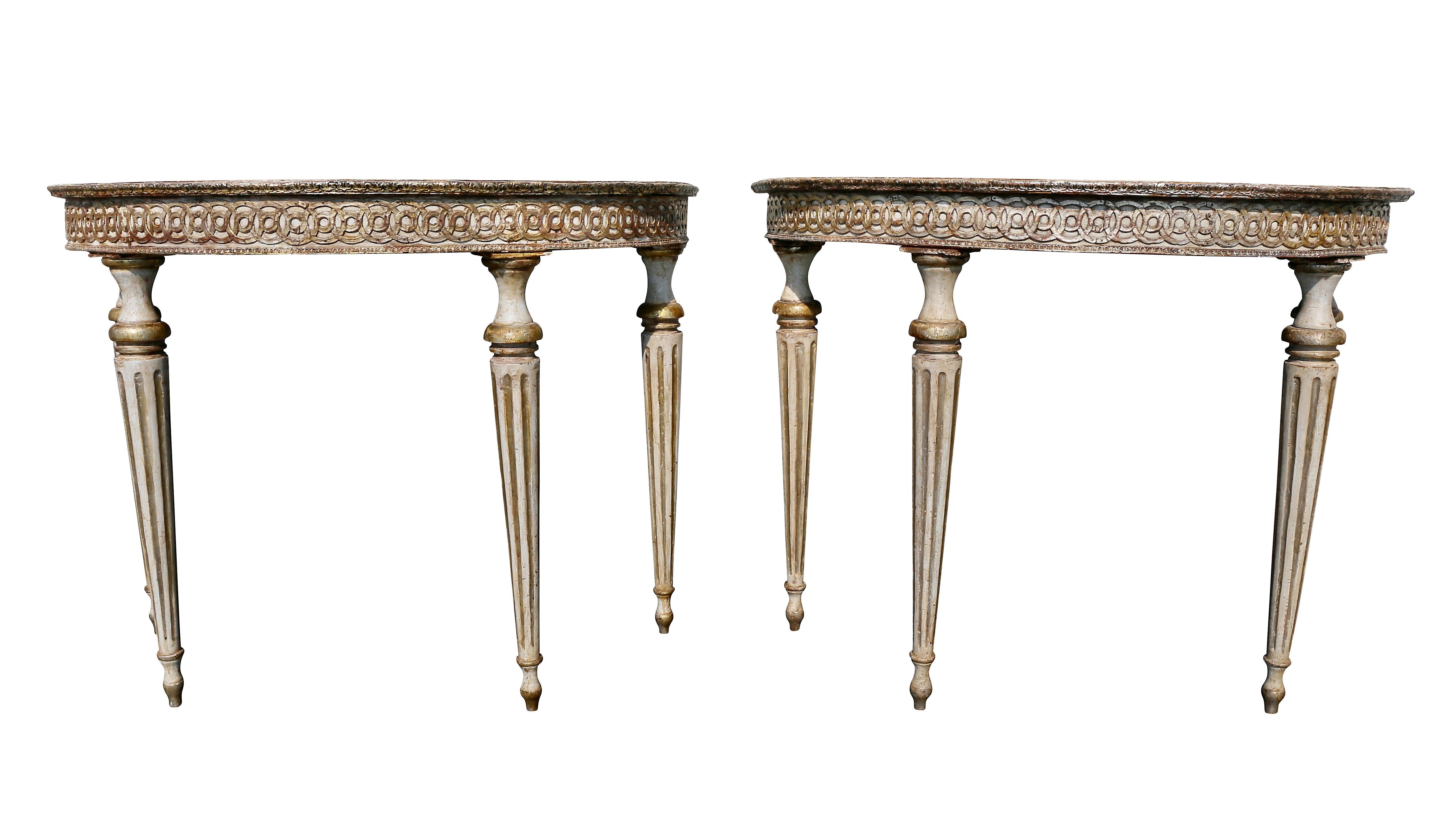 Each with demilune shape tops painted with floral designs, carved guilloche frieze with circular tapered fluted legs.