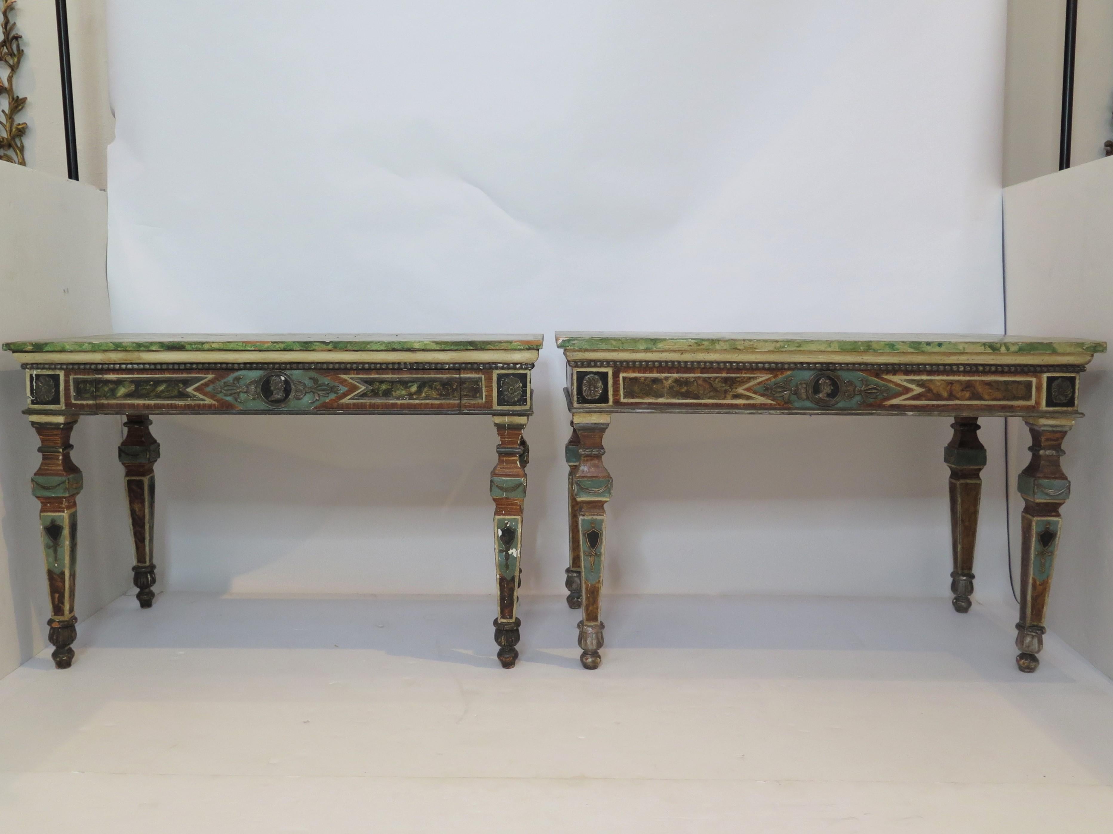 A pair of Italian neoclassic style polychrome console tables. The faux marble variegated green-painted rectangular top over conforming rectangular border with central drawer on tapering baluster-form legs would be a great addition to any home 

The