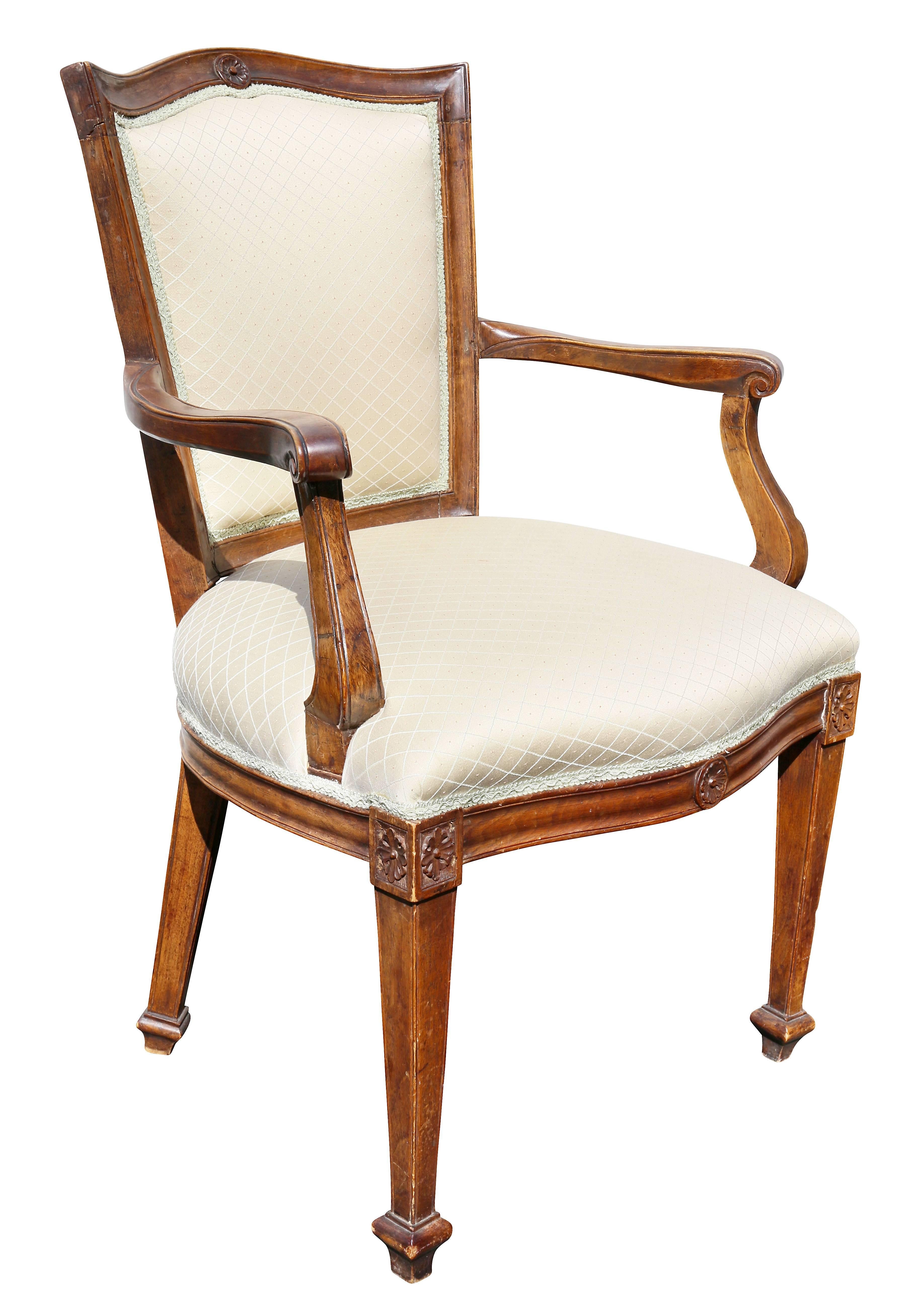 Each with serpentine crest rail with central circular carving over an upholstered back and feat, raised on square tapered legs.