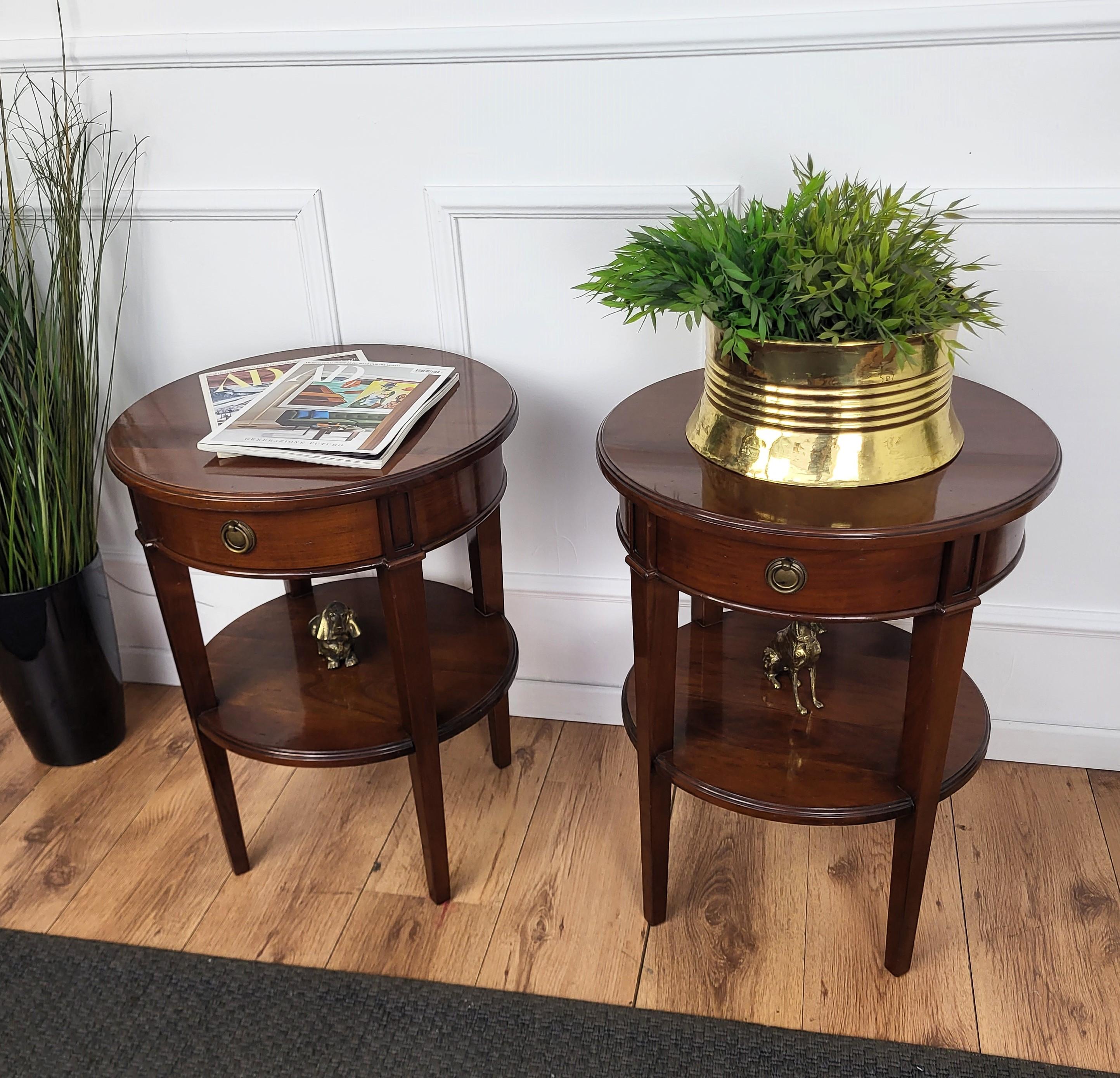 Very elegant and refined pair of Italian 1940s Art Deco sofa side tables with great round design shape and beautiful color of walnut wood, central drawer and brass handles. This pair makes a great look in any style living room, as a complementary