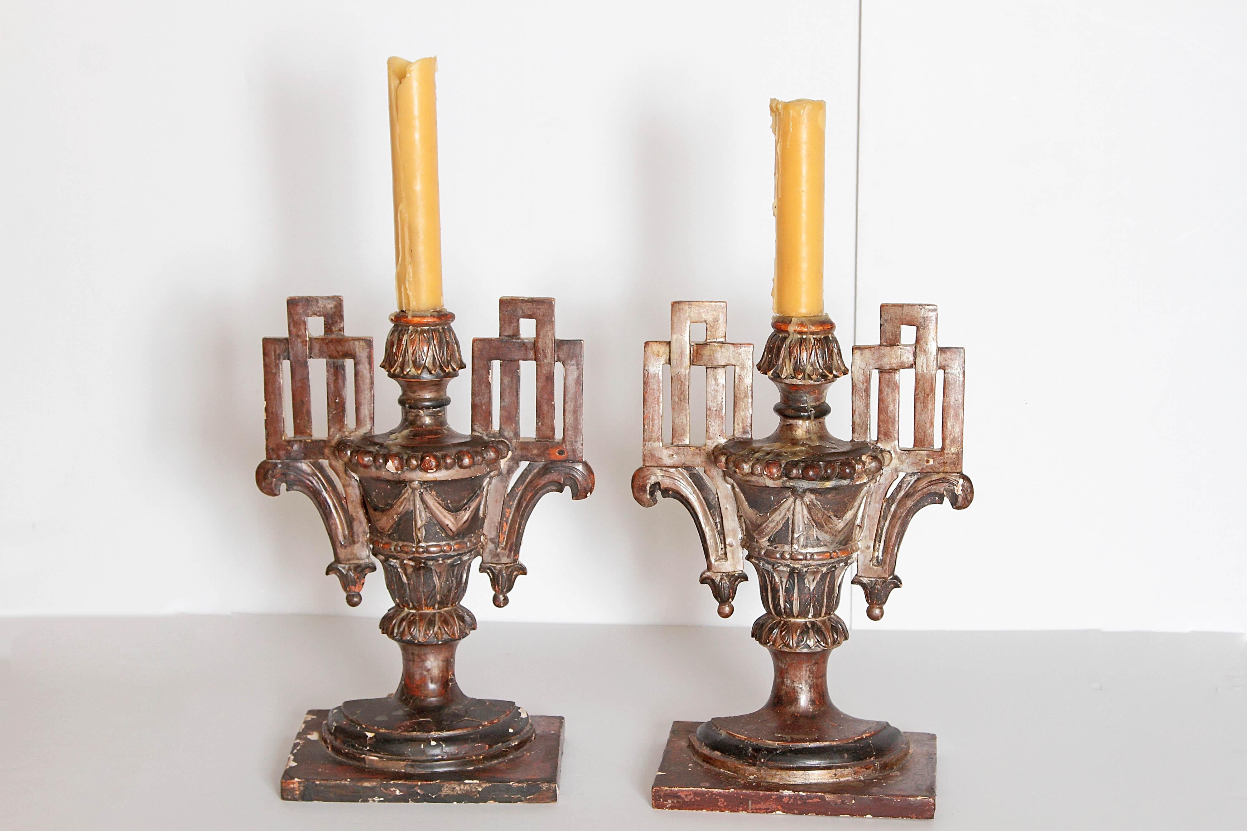 A pair of late 18th century Italian giltwood candleholders. Central carved urn form flanked by Greek key forms. Made to fit against the wall, late 18th century, Italy.