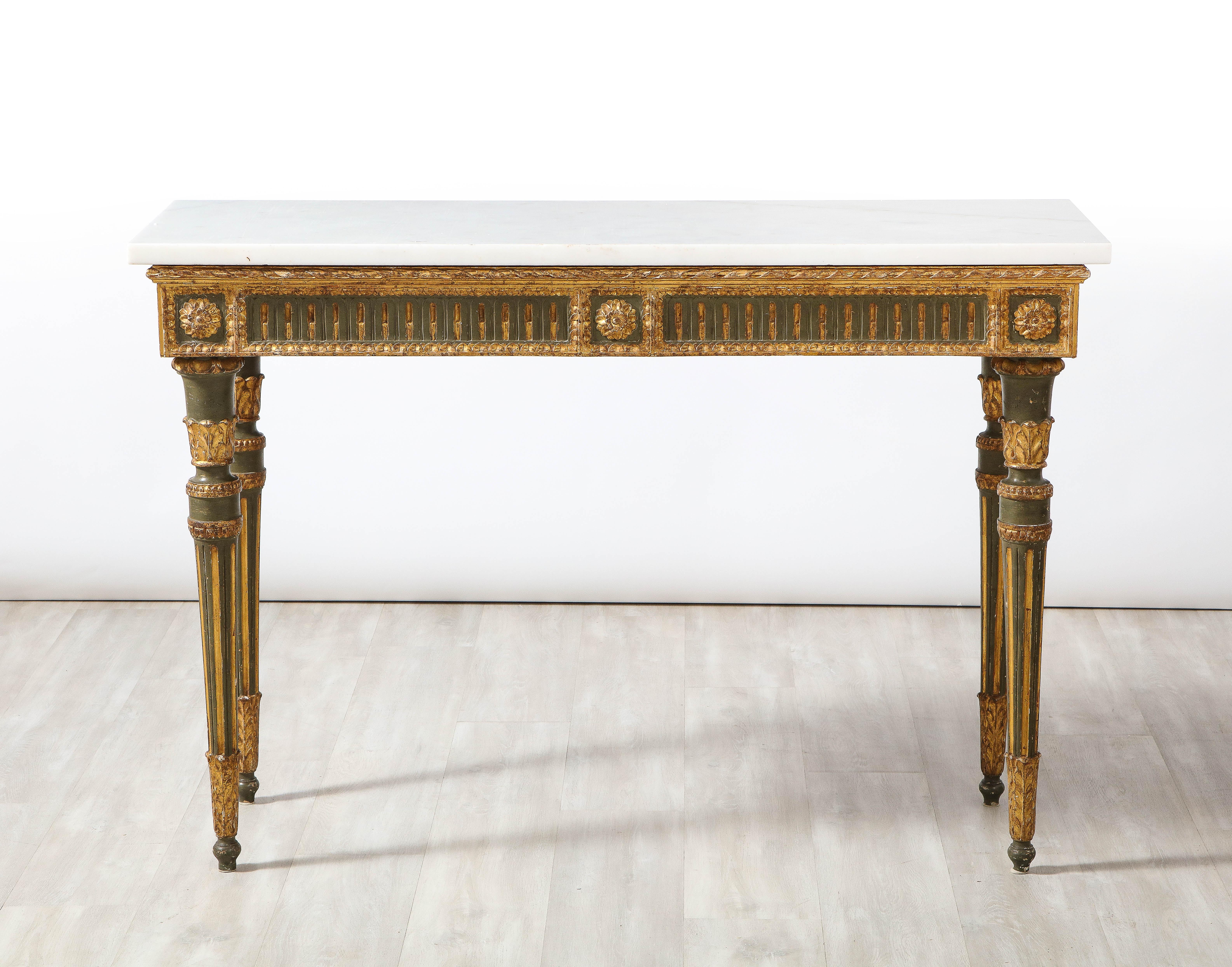 A pair of exquisite and elegant Florentine 18th century Louis XVI period carved, painted and gilded wood Neoclassical console tables, with Carrara white marble tops. The rectangular frieze is decorated on the front and sides with carved and gilded