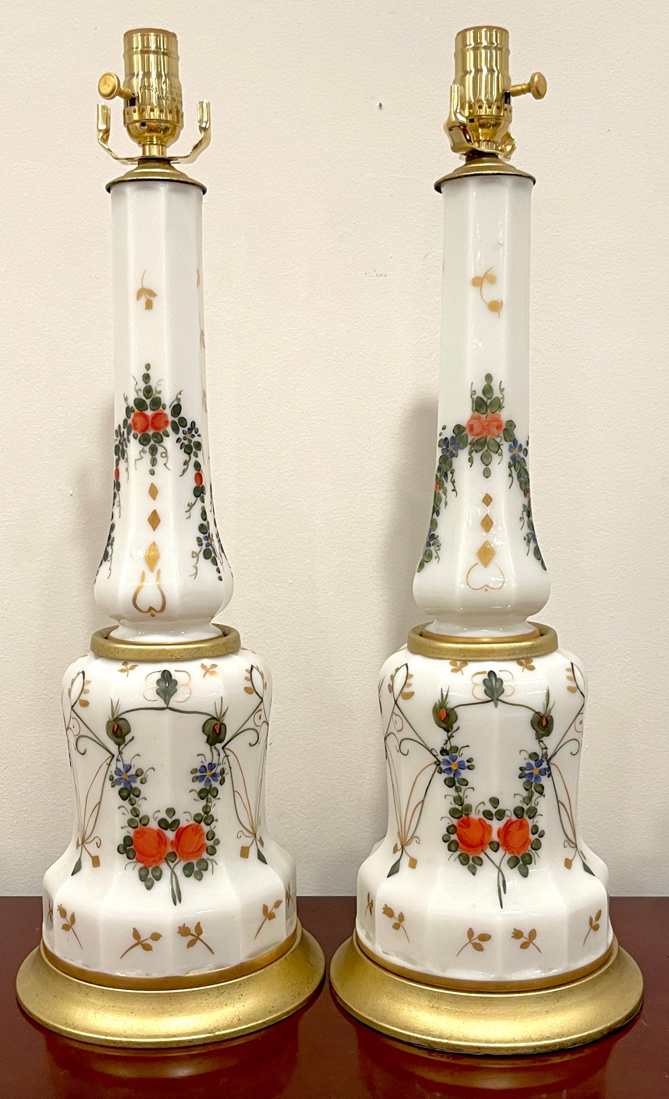 Pair of Italian Neoclassical Floral Enameled Opaline Glass Column Lamps 
Italy, Circa 1960s

Pair of Italian Neoclassical floral enameled opaline glass column lamps, originating from the 1960s. These stunning lamps consist of two-section columns,