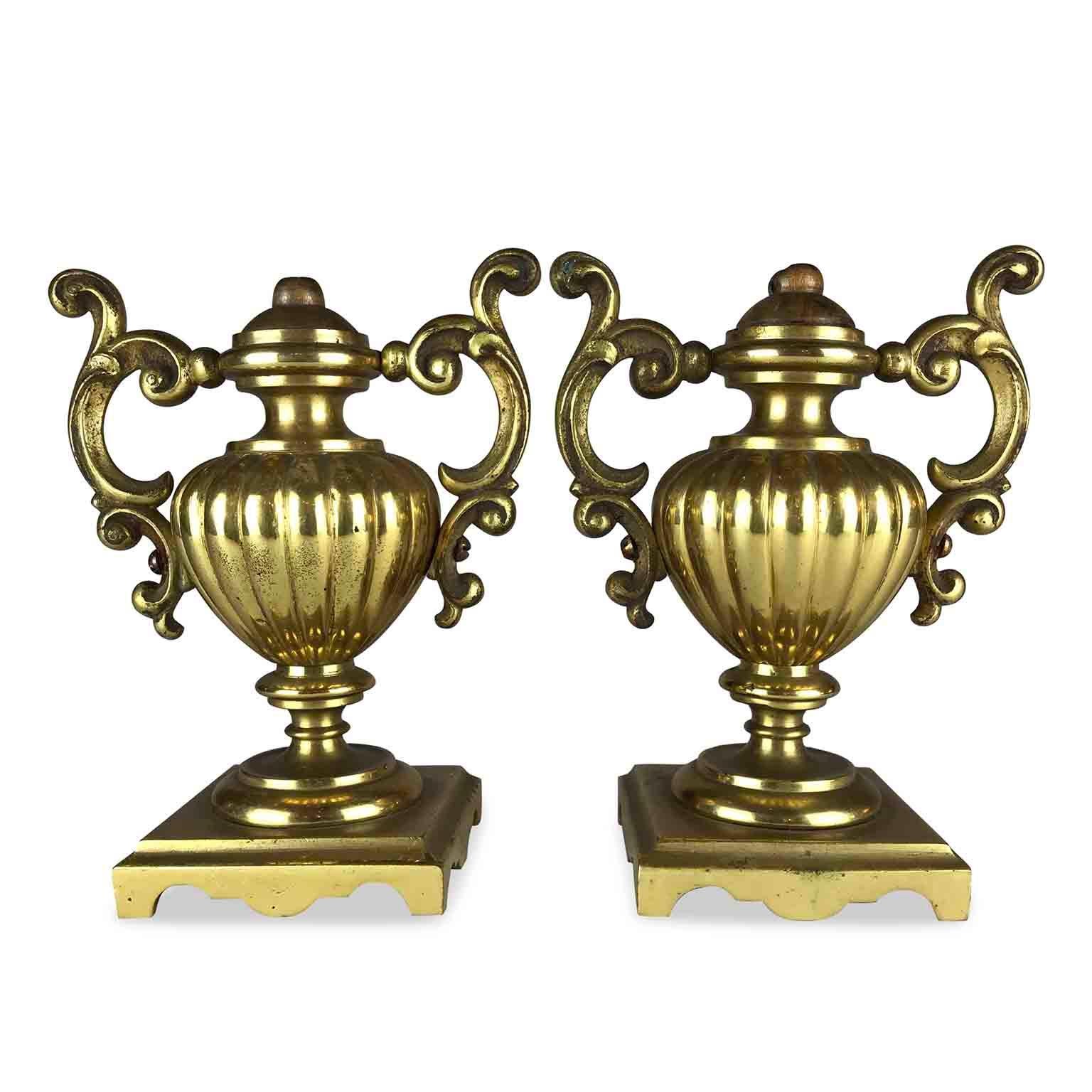Pair of 19th Century Neoclassica gilded bronze urns from Italy. A pair of amphora shaped vases in mercury gilded and polished bronze. Very small center vases, featuring a fluted body and two double-scroll handles, these antique bronze portapalme,