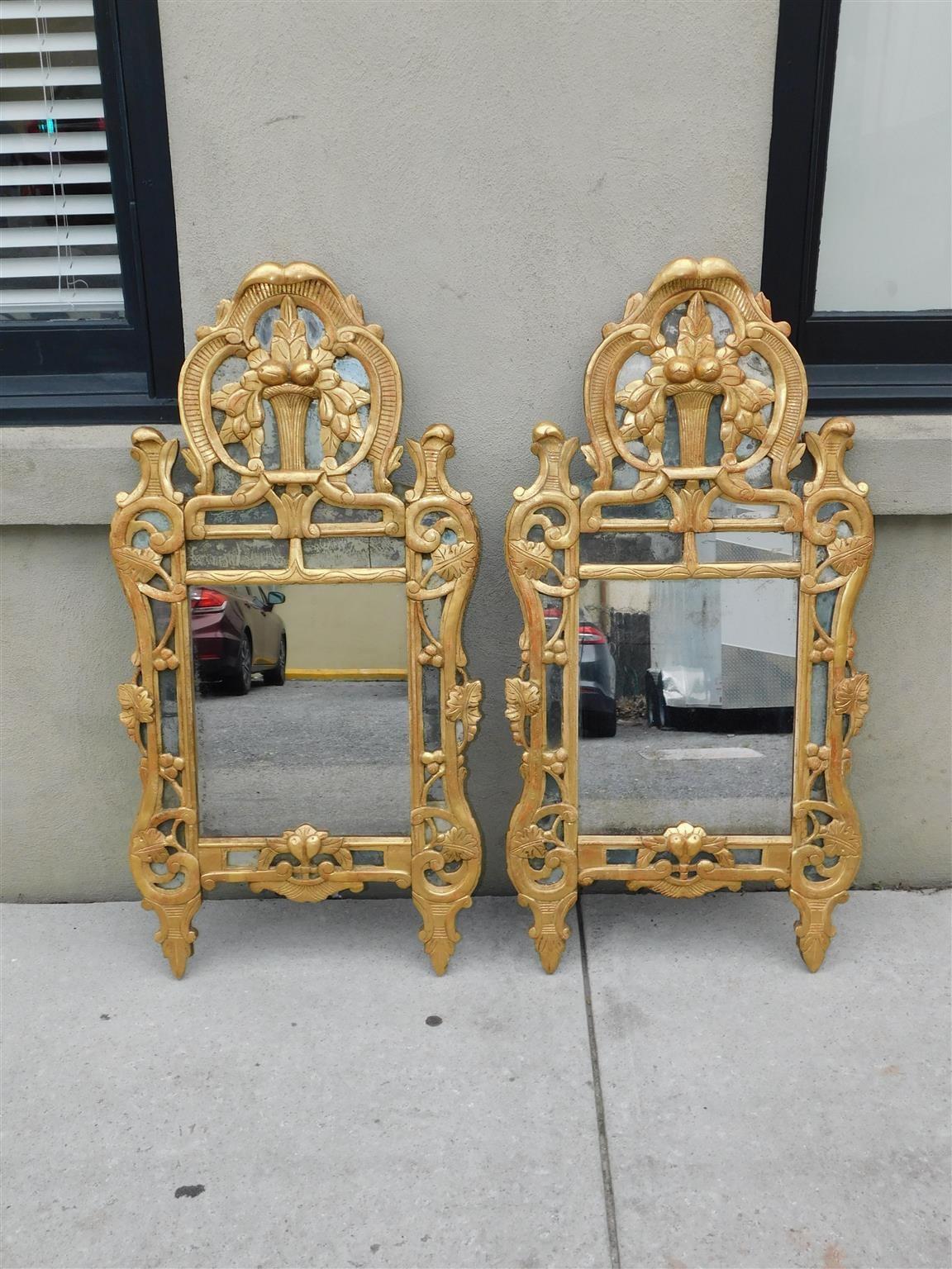 Pair of Italian Neoclassical gilt wood and gesso foliage fruit basket wall mirrors, Late 18th Century. 
Mirrors retain the original silvered glass and wood backing.