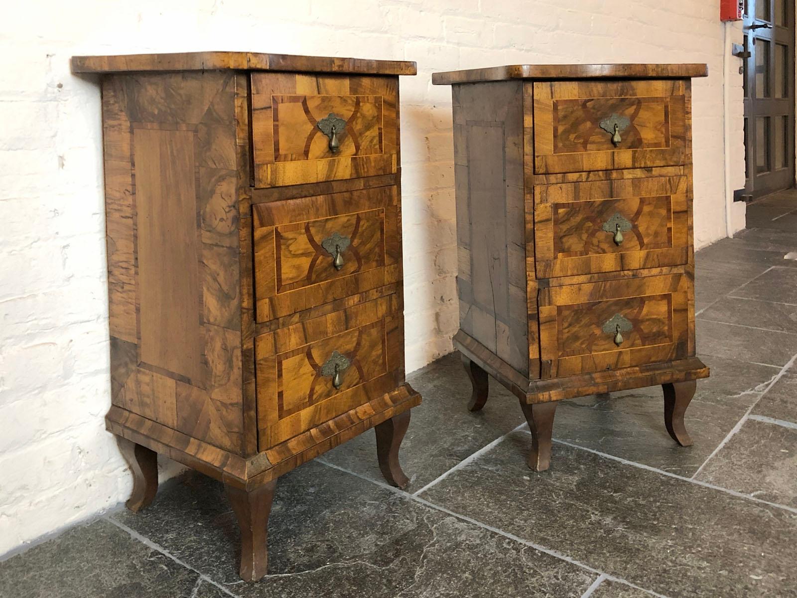 Pair of diminutive Italian Neoclassical Comodini or night stands, the walnut veneer with a rich, deep patina, shaped tops over three drawers, on cabriole legs. Elegant, petit, understated, with a beautiful color, they make a perfect fit for a small