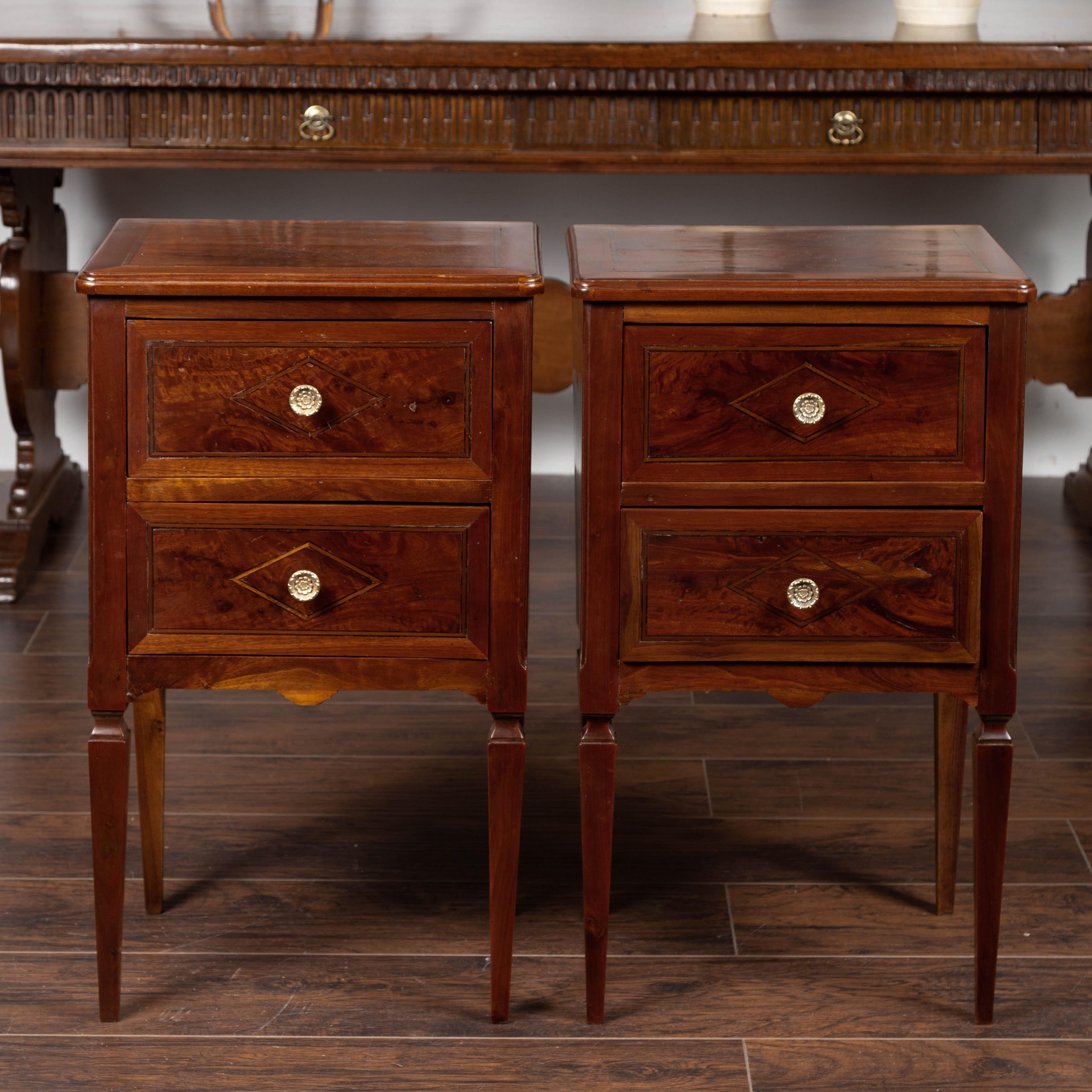 A pair of Italian neoclassical style walnut commodes from the mid-19th century, with tapered legs and inlaid diamond motifs. Born in Italy during the second quarter of the 19th century, each of this pair of walnut commodes features a rectangular top