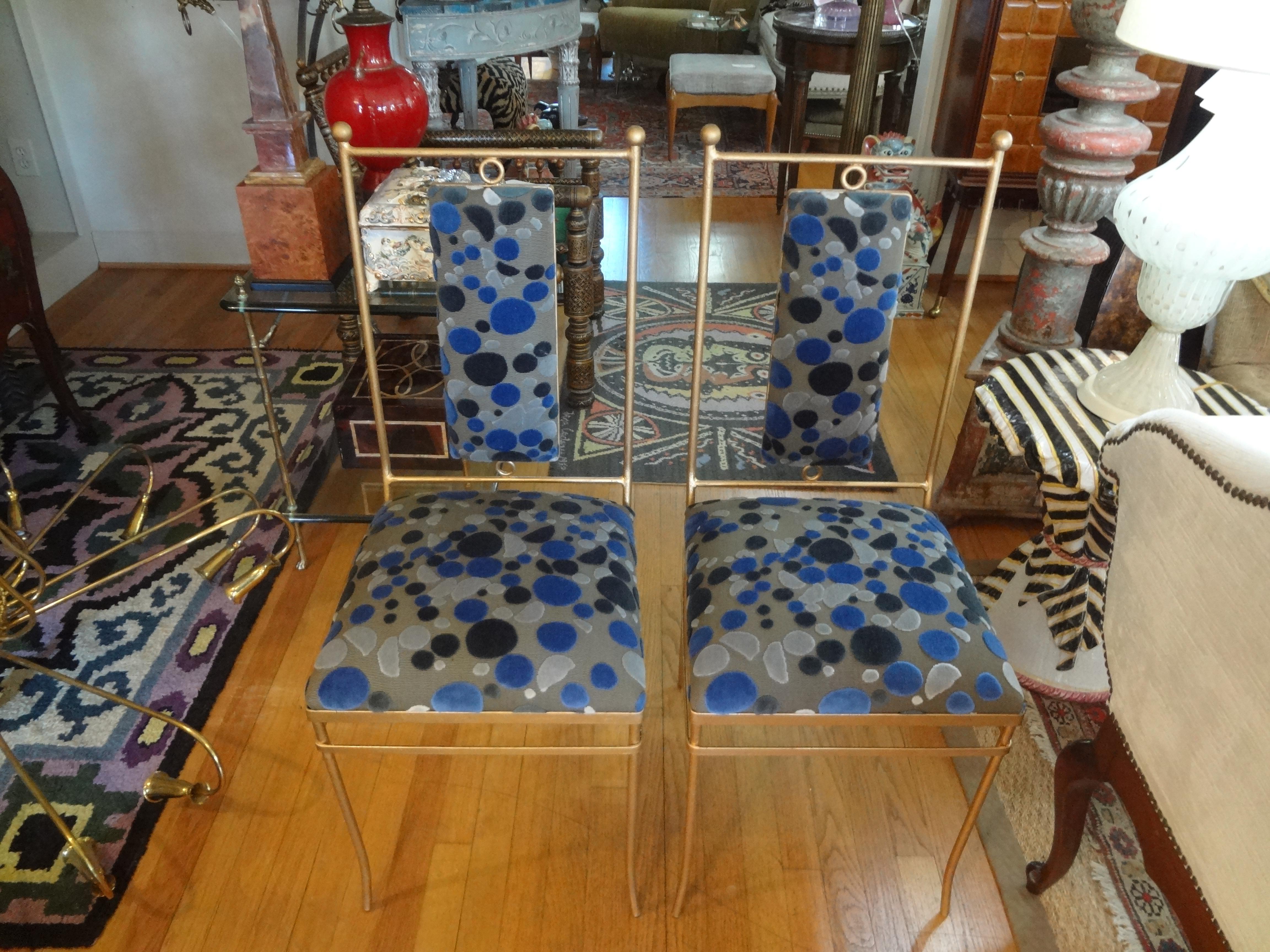 Stunning pair of Italian midcentury neoclassical style gilt iron chairs professionally upholstered in a designer cut velvet fabric. This pair of versatile Italian gilt wrought iron side chairs will work in a variety of design themes and rooms.