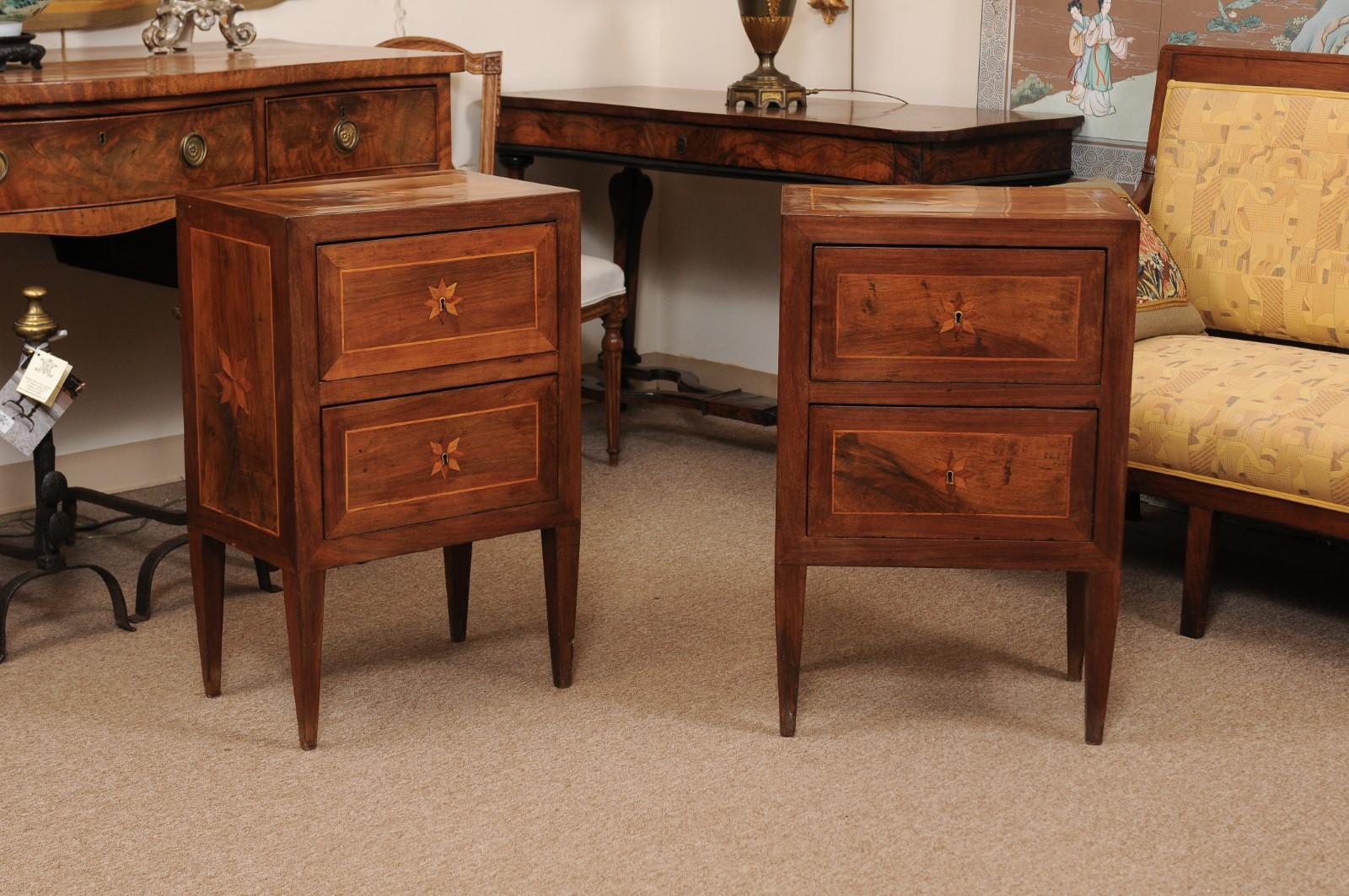 A pair of late 19th century neoclassical style inlaid walnut commodini featuring 2 drawers and tapered legs.
