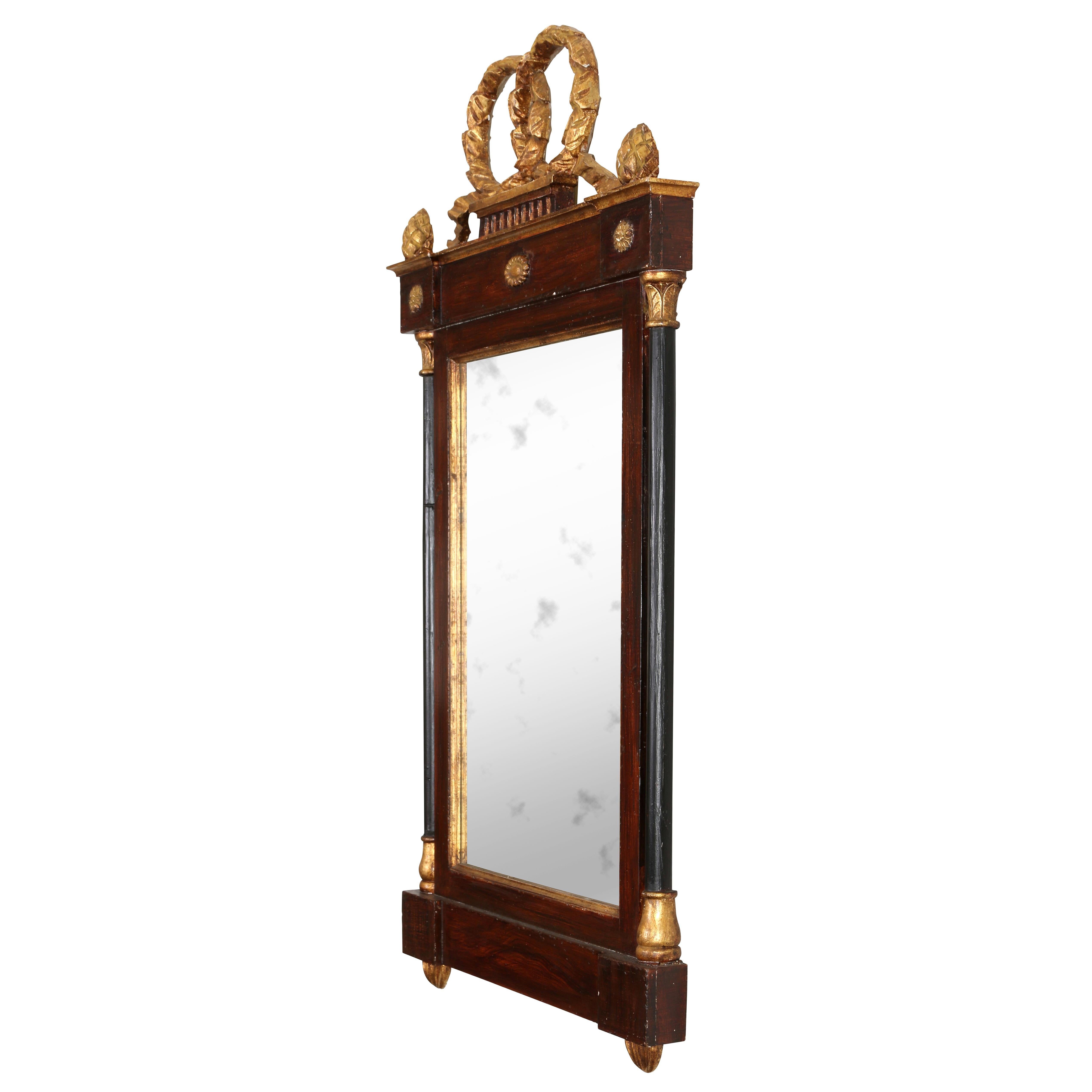 Two is always better than one! This is a great looking pair of 19th-century Italian mahogany mirrors in the Neoclassical style. Although the mirrors have a simple, understated style, they feature many lovely details, including gilt decorated