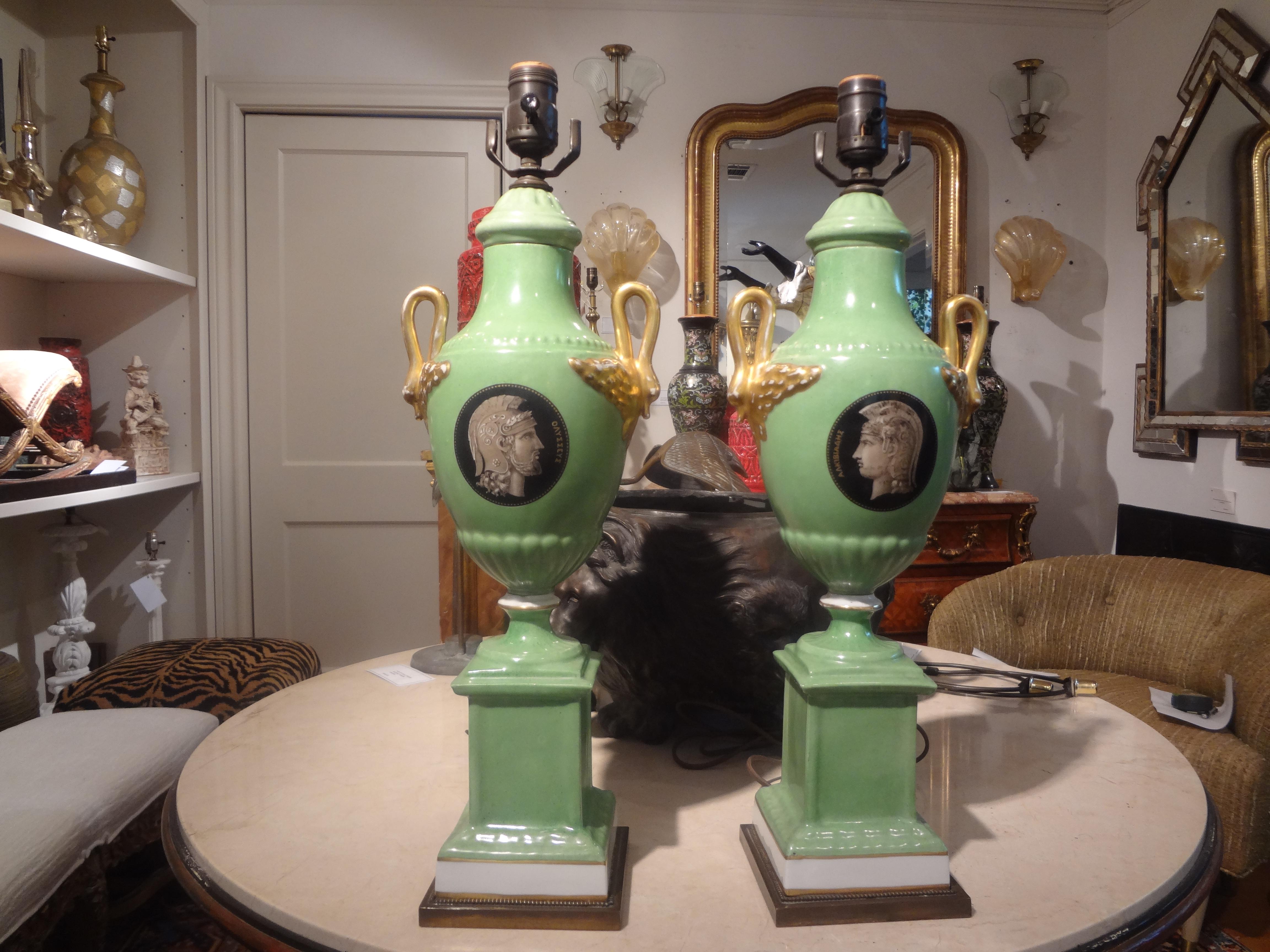 Pair of Italian Neoclassical style porcelain lamps.
Stunning pair of Italian Neoclassical style Porcelain lamps with opposing Greek inspired faces, gilt swan handles and brass bases. These gorgeous lamps in a lovely l shade of green have been