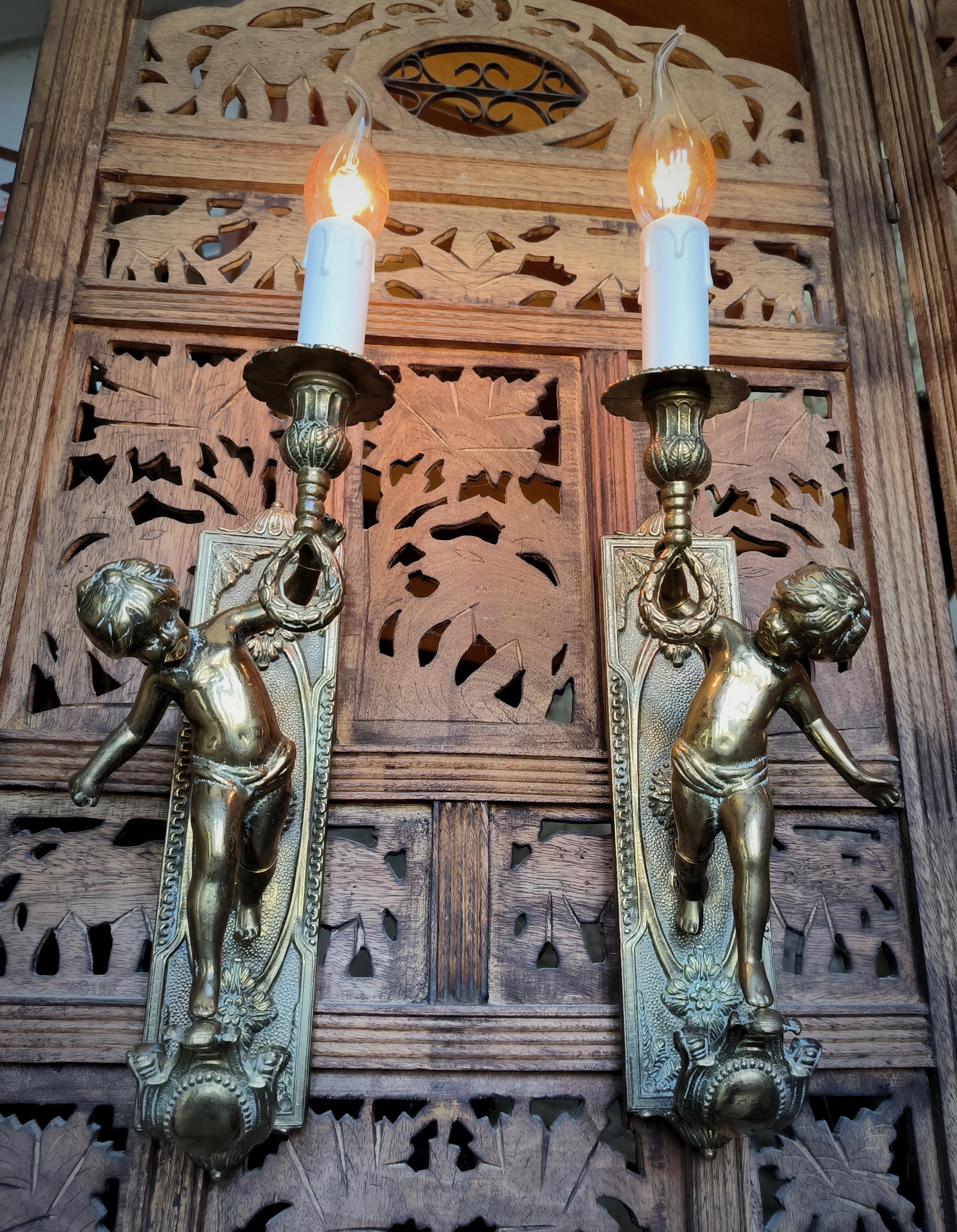 Pair of Italian, Neoclassical style, solid bronze Cherub sconces. Circa 1950s 1