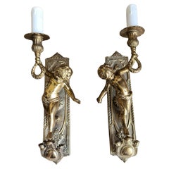 Pair of Italian, Neoclassical style, solid bronze Cherub sconces. Circa 1950s