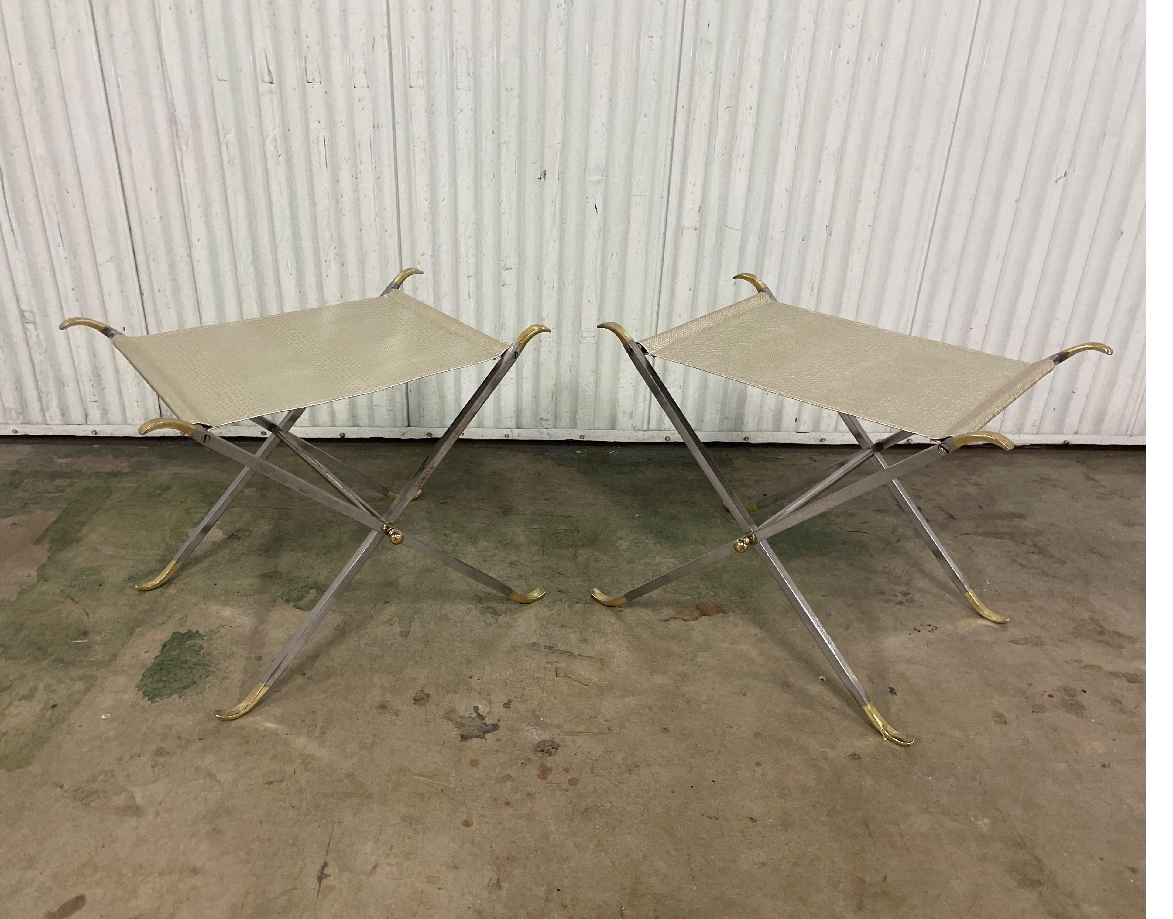 Pair of steel and brass Neoclassical X base folding Campaign stools attributed to Maison Jansen.