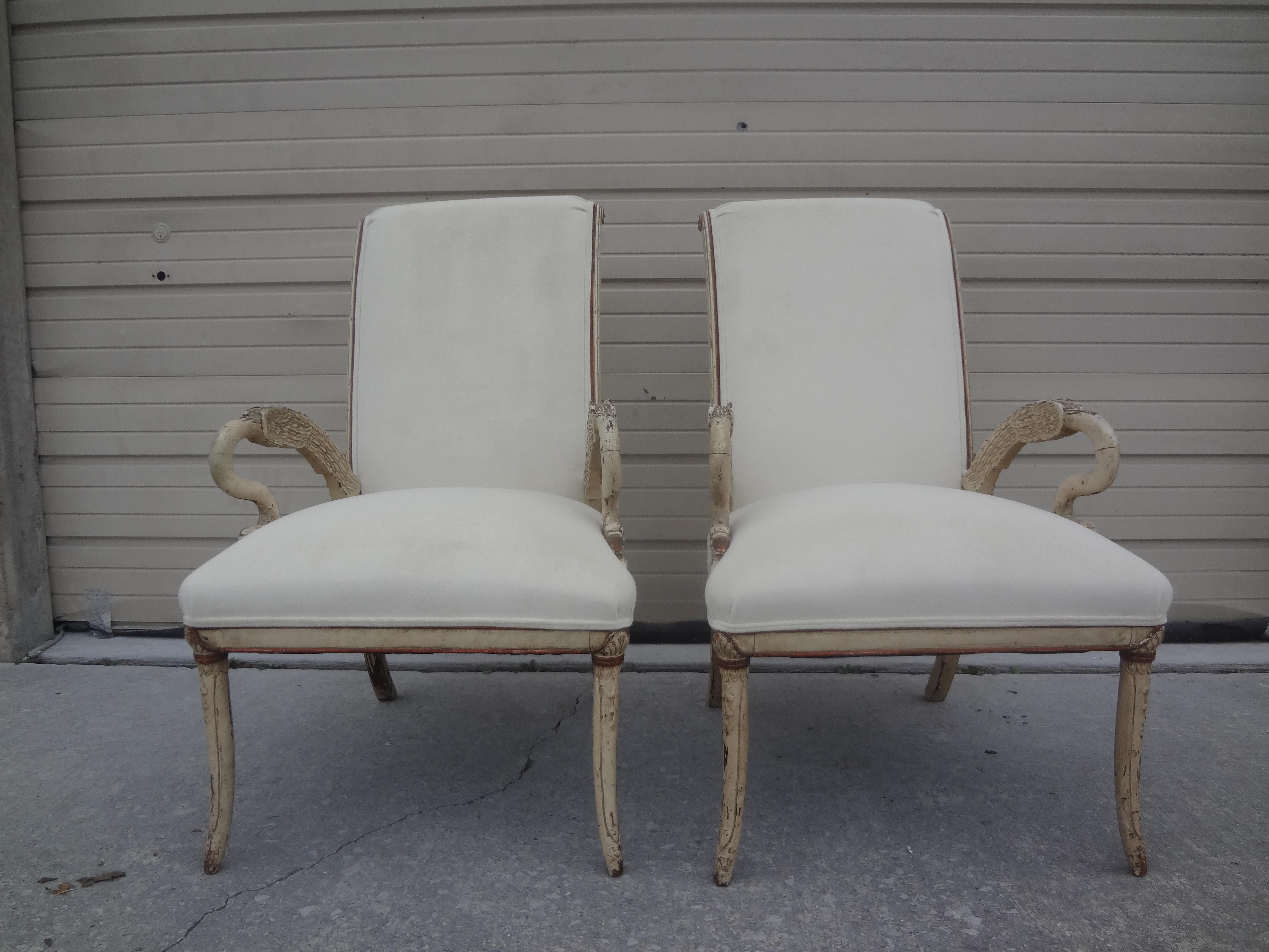 Pair of Italian neoclassical style swan chairs.
This lovely pair of Italian neoclassical style, Empire style or Gustavian Style armchairs have beautifully carved swan arms and are professionally upholstered in cream colored velvet. Versatile