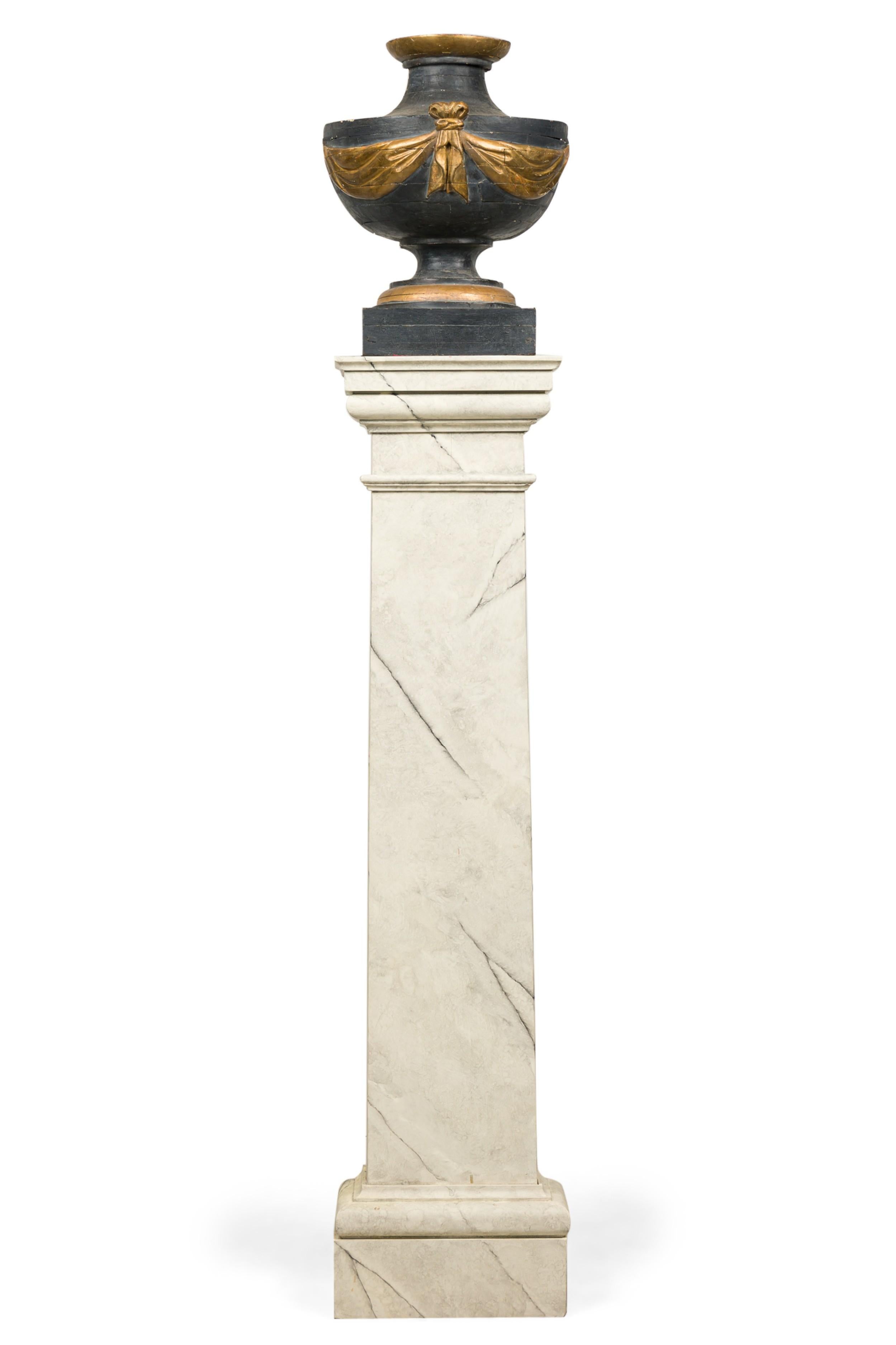 PAIR of Italian Neo-classic (19th Century) pilasters /pedesals having ablack painted urn with gold painted and parcel-gilt swag and trim mounted on faux white painted marble pedestals (PRICED AS PAIR)
