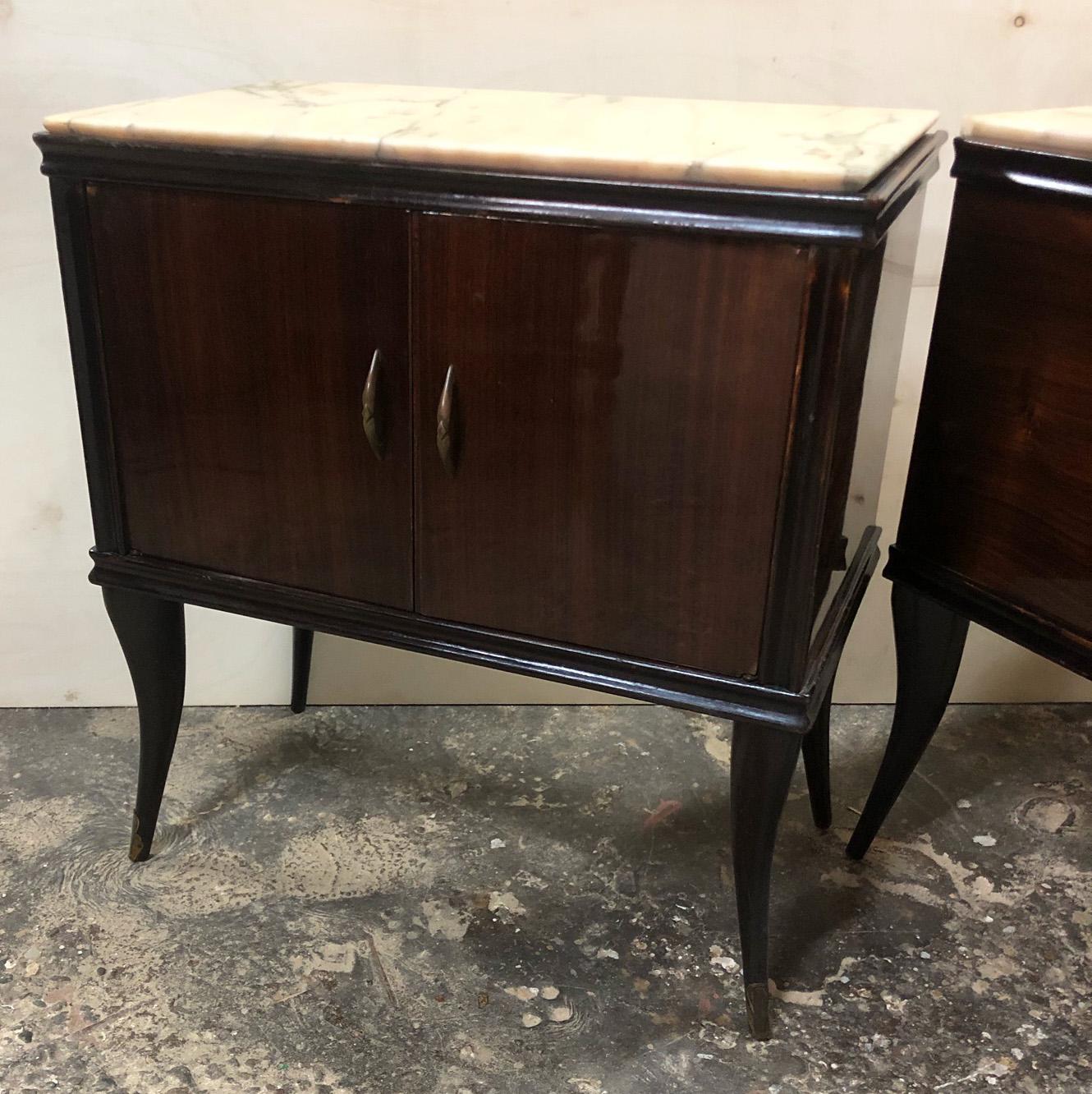 Pair of Italian night stands dating back to the mid-1900s. 
The coloring is original in patinain and wood walnut with cream marble.
Original color and handles.
Comes from an old elegant house in the Pisa area of Tuscany.
As shown in the