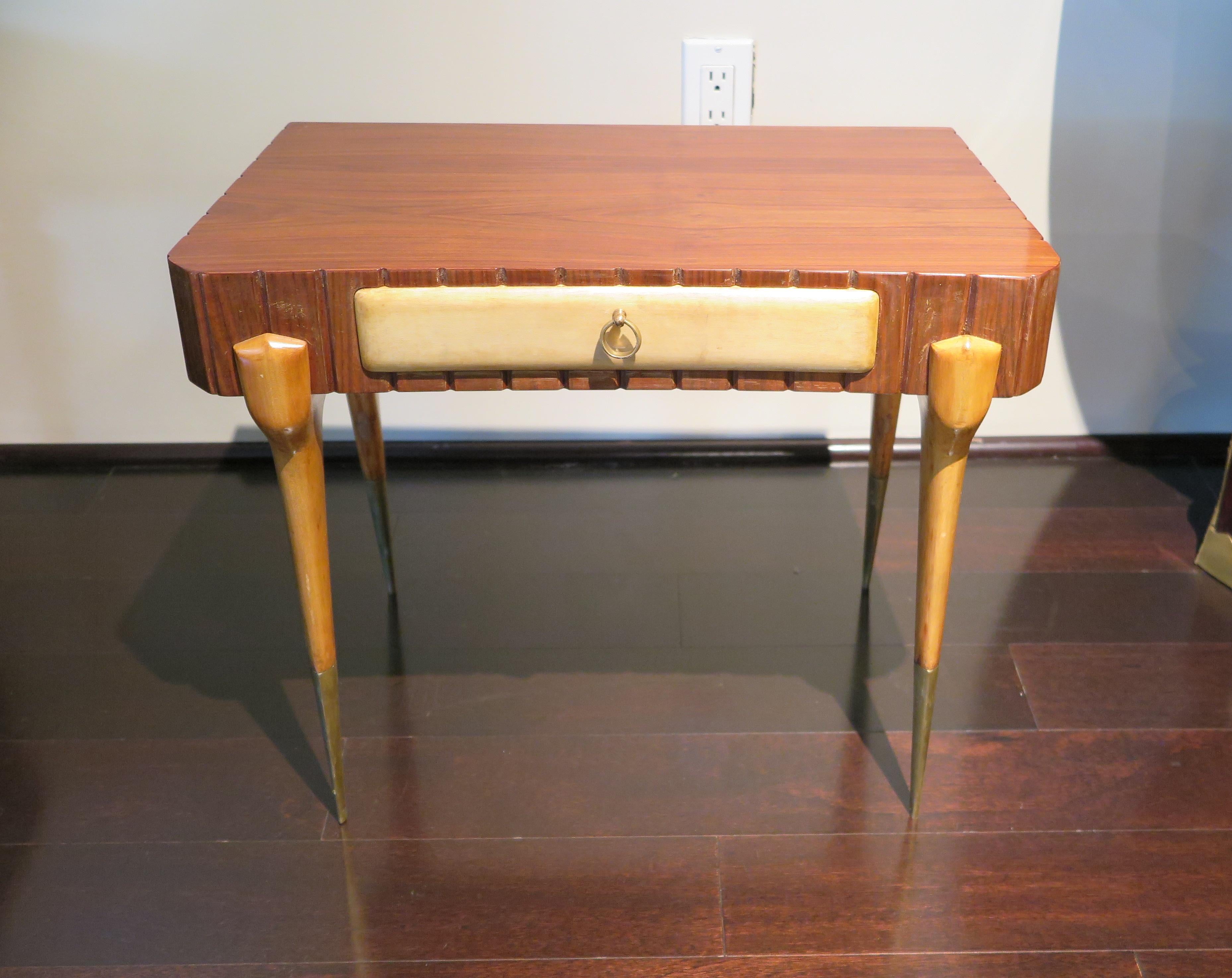 Pair of nightstands with frame in rosewood with ribbed design. Drawer fronts in parchment (goatskin) and legs in citron wood. Large tapered brass feet caps and ring drawer pull in brass. Original condition.