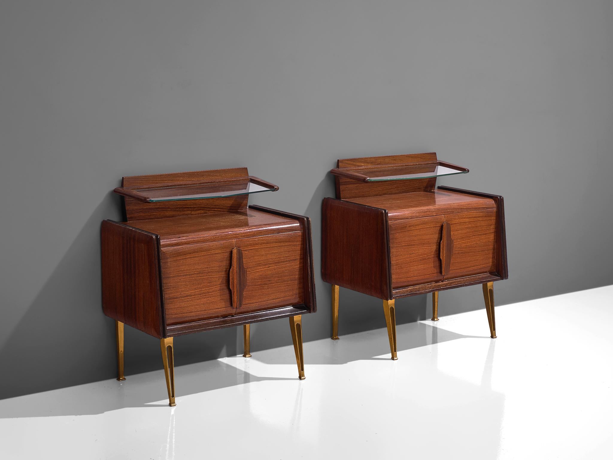 Pair of night stands, teak, glass and brass, Italy, 1960s.

These two side tables or nightstands are both refined and elegant in every way. The glass top floats above the small cabinet. Executed with double doors with sculptural handles. The brass