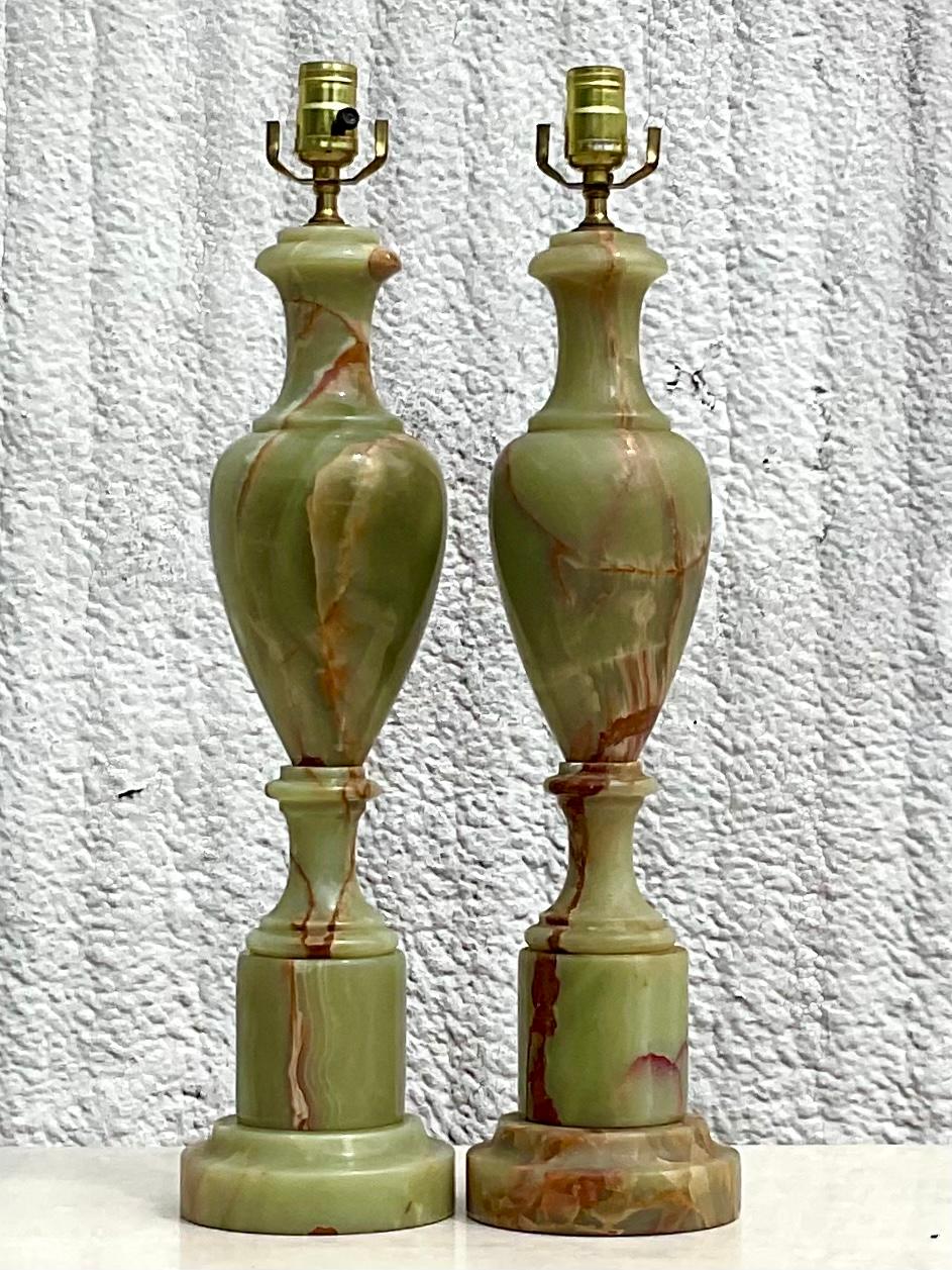 Fabulous pair of green onyx table lamps. Beautiful jade green with rich brown veining. Acquired from a Palm Bech estate.