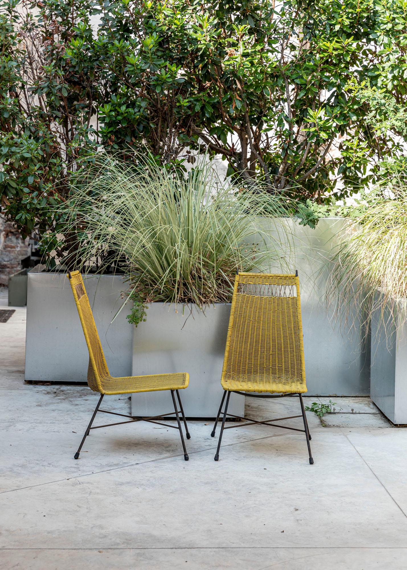 Set of two vintage outdoor chairs, Italy, circa 1950. 
Pair of iron and yellow pvc wire chairs, the seat and backrest are handmade with pvc wire.
Beautiful cane details in the upper part of the backrest.