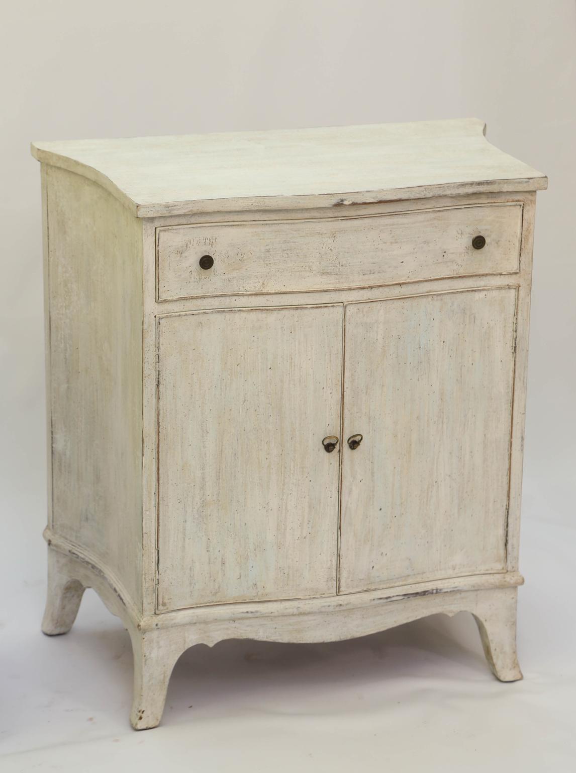 Pair of painted cabinets, each having a shaped top, its single drawer over double cupboard doors, its bowed apron raised on bracket feet.

Stock ID: 2430.